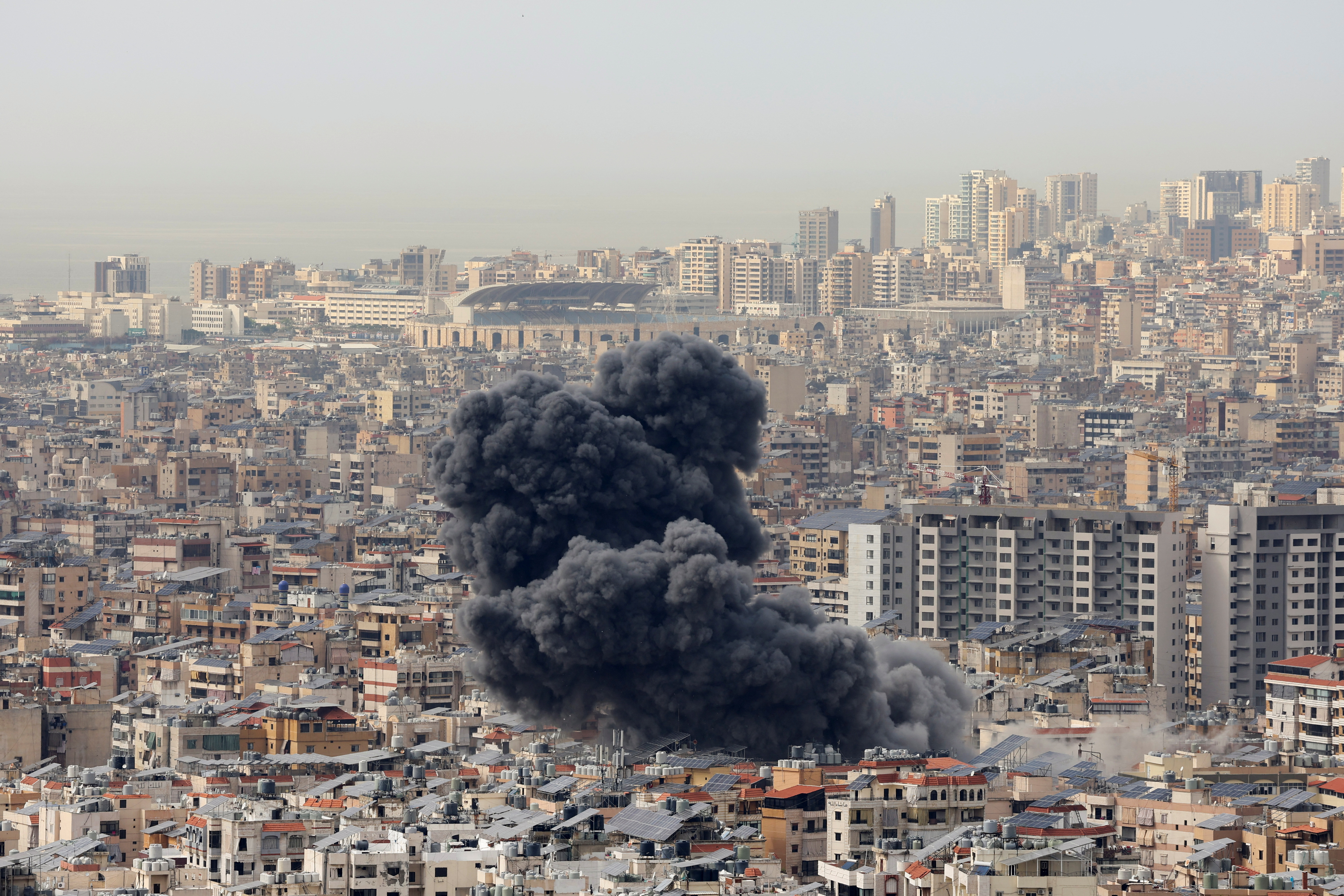 Smoke billows over Beirut's southern suburbs following Israeli strike.