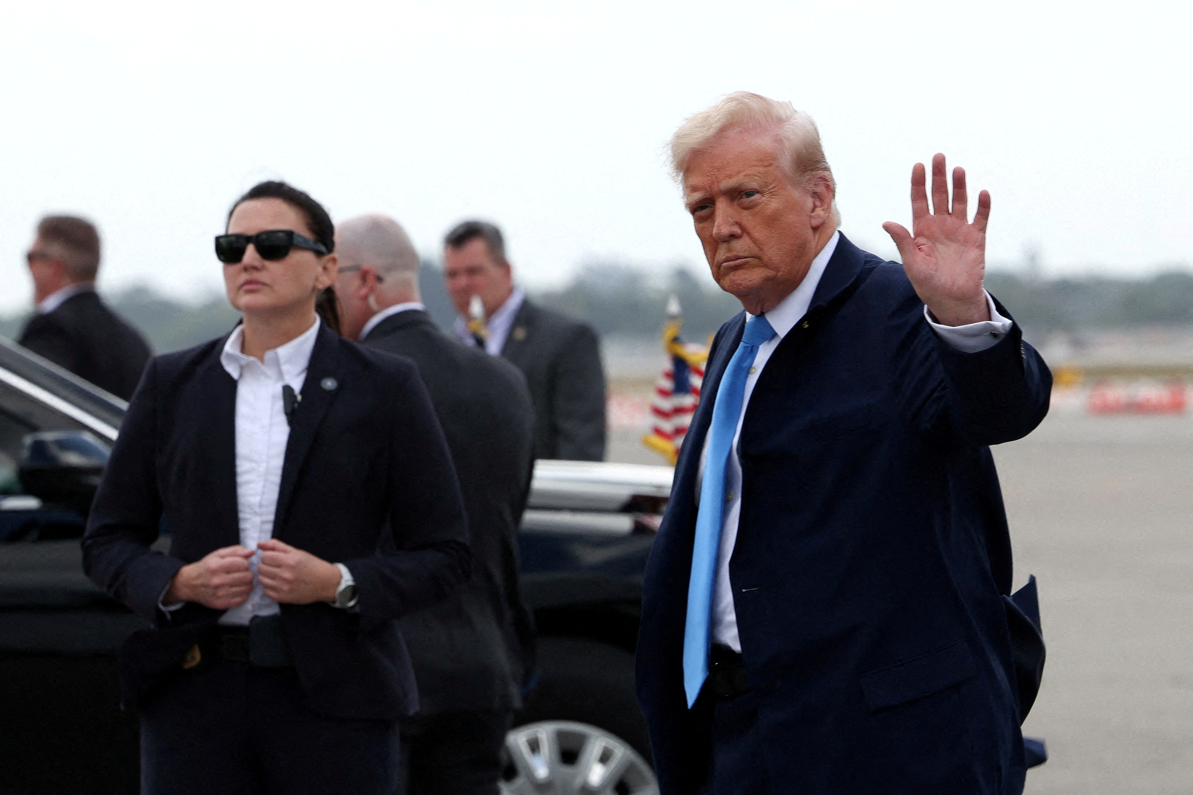 FILE PHOTO: U.S. President Donald Trump waves as he arrives in West Palm Beach, Florida, U.S., March 28, 2025. REUTERS/Kevin Lamarque/File Photo