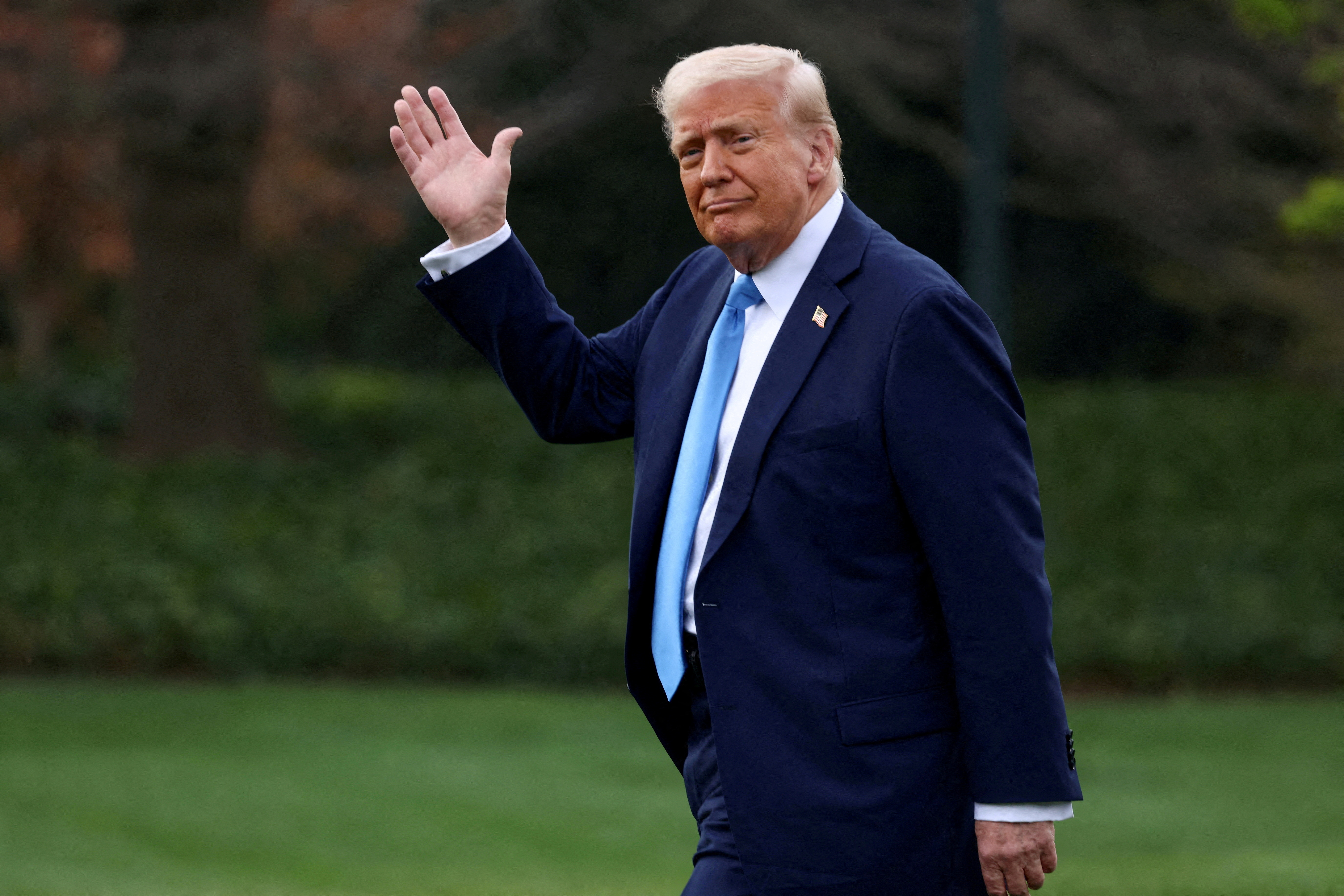 President Donald Trump waves as he walks