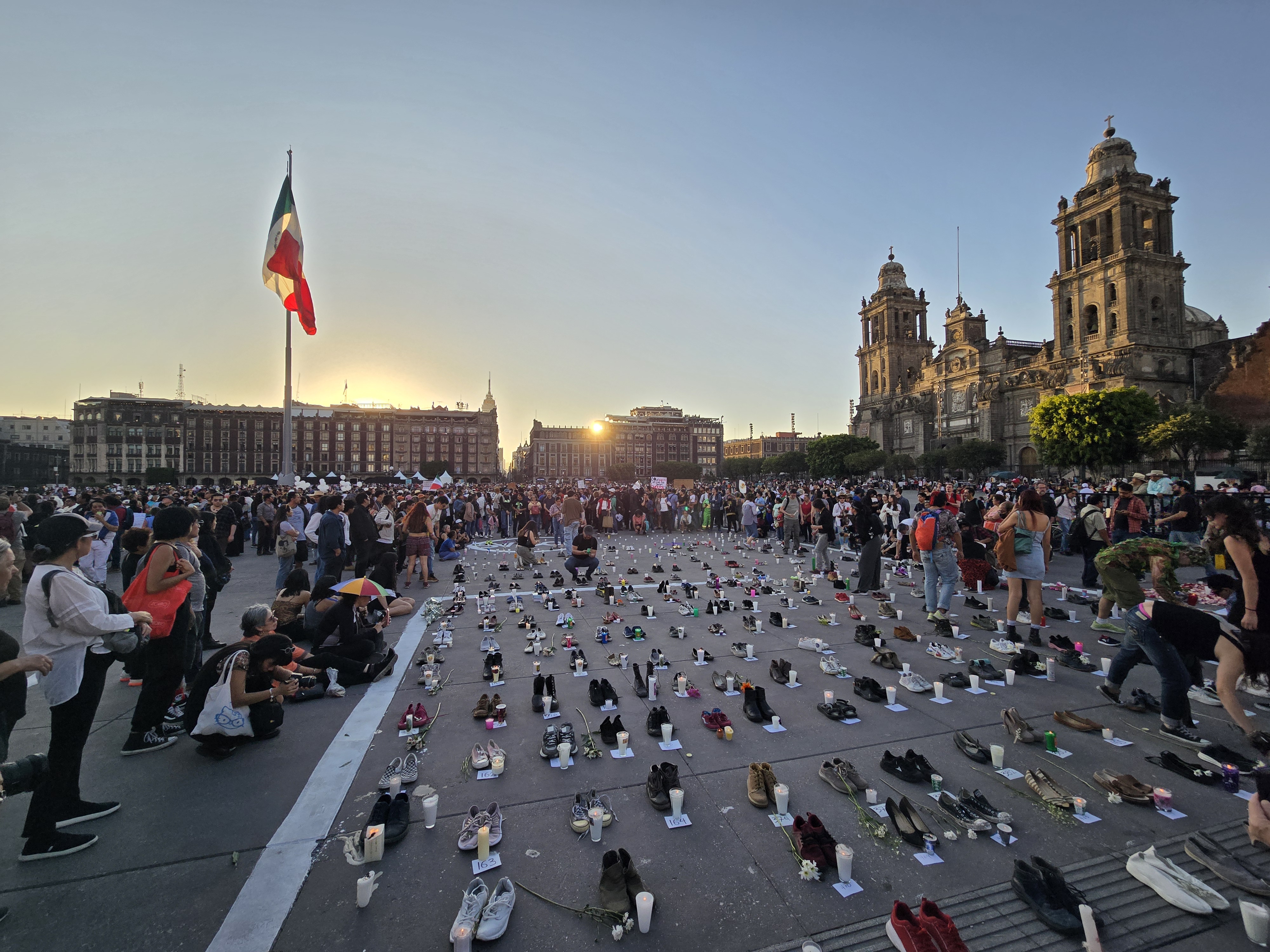 A view of a protest that lined up hundreds of pairs of shoes in Mexico City's Zocalo Plaza at sunset