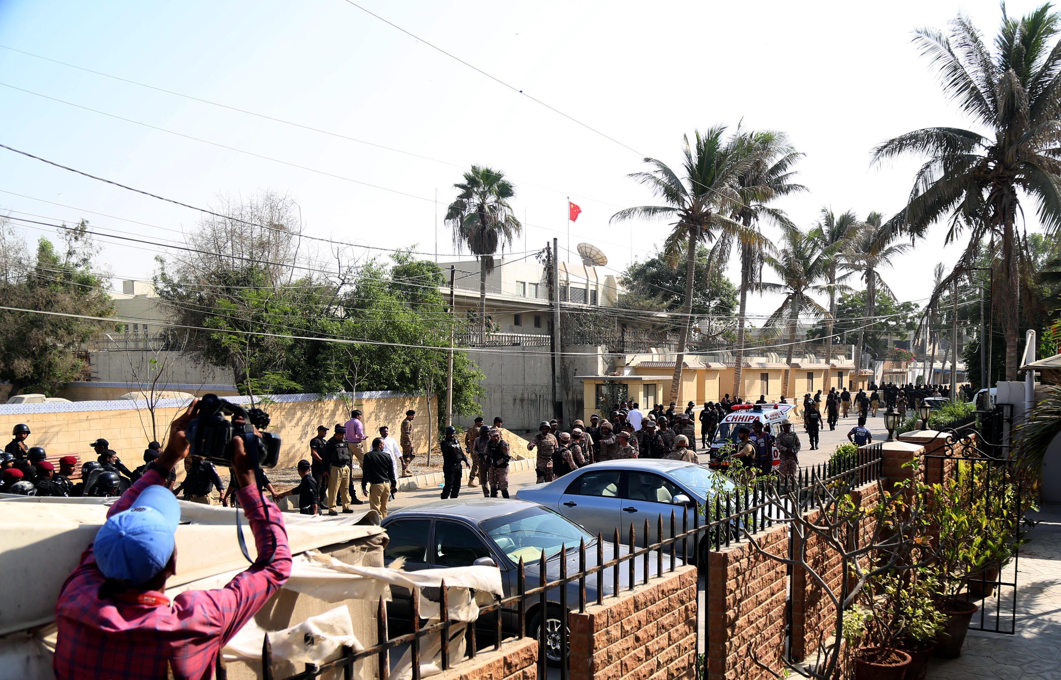 epa07184079 Pakistani security personnel stand outside the Chinese consulate after an attack in Karachi, Pakistan, 23 November 2018. At least two policemen were killed when unidentified gunmen stormed the Chinese consulate in the Pakistani port city of Karachi. At least three gunmen were also killed in the attack, which was reportedly claimed by the Baloch Liberation Army. EPA-EFE/REHAN KHAN