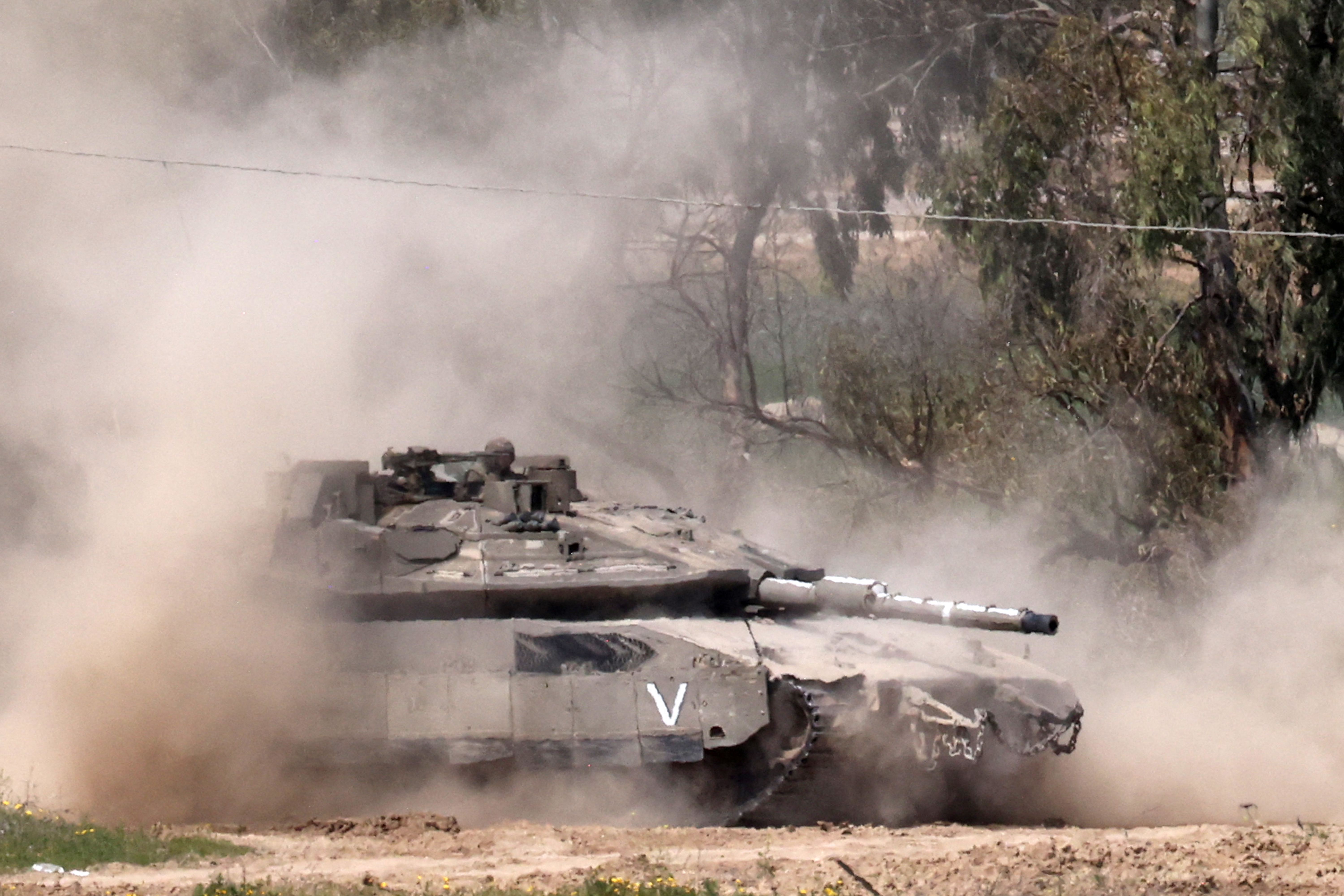 An Israeli army Merkava main battle tank moves at a position in southern Israel along the border fence with the northern Gaza Strip on March 18, 2025. Israel on March 18 unleashed its most intense strikes on the Gaza Strip since a January ceasefire, with rescuers reporting 220 people killed, and Hamas accusing Benjamin Netanyahu of deciding to "resume war" after a deadlock on extending the truce. (Photo by Menahem KAHANA / AFP)
