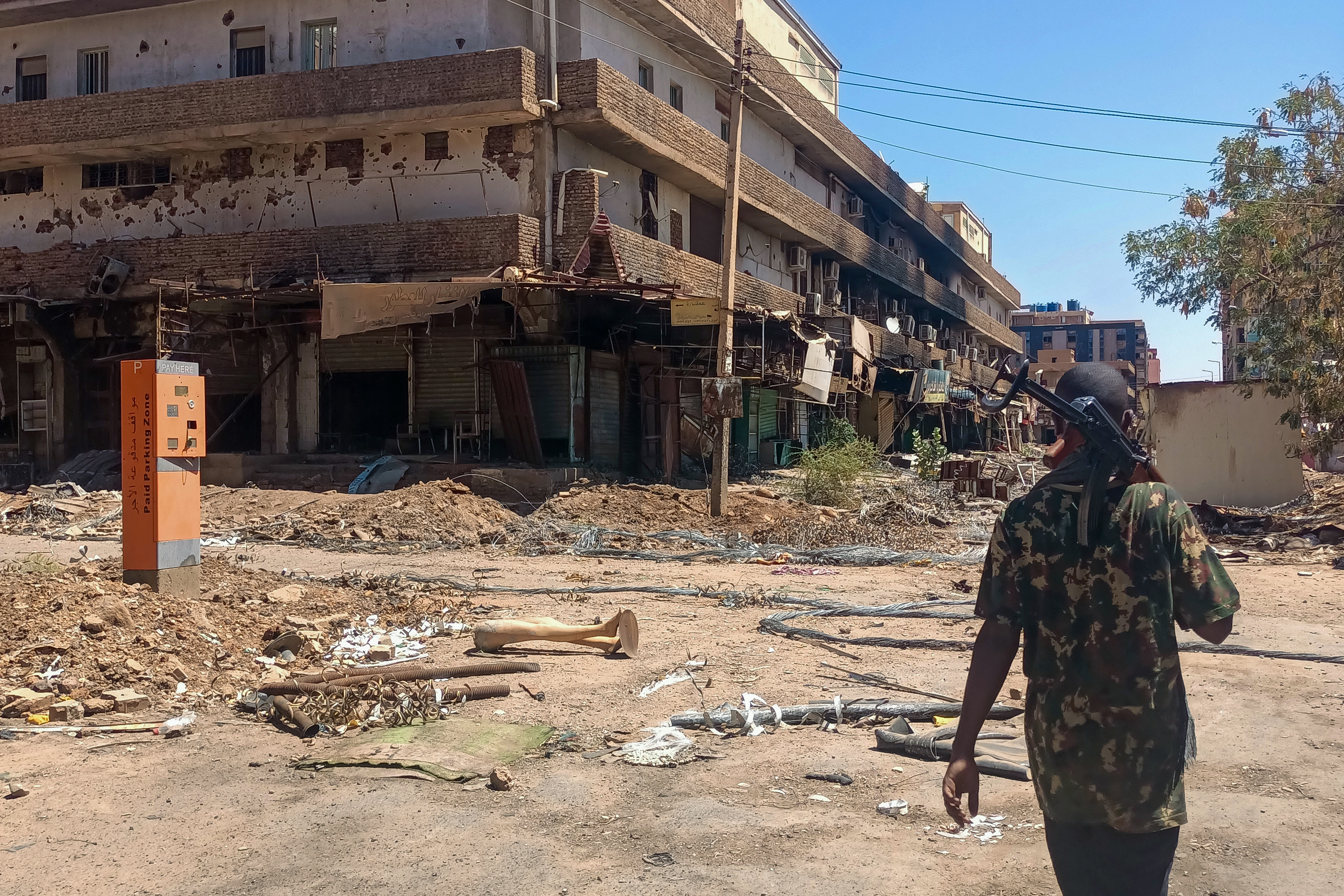 A fighter loyal to the army patrols a market area in Khartoum on March 24, 2025.