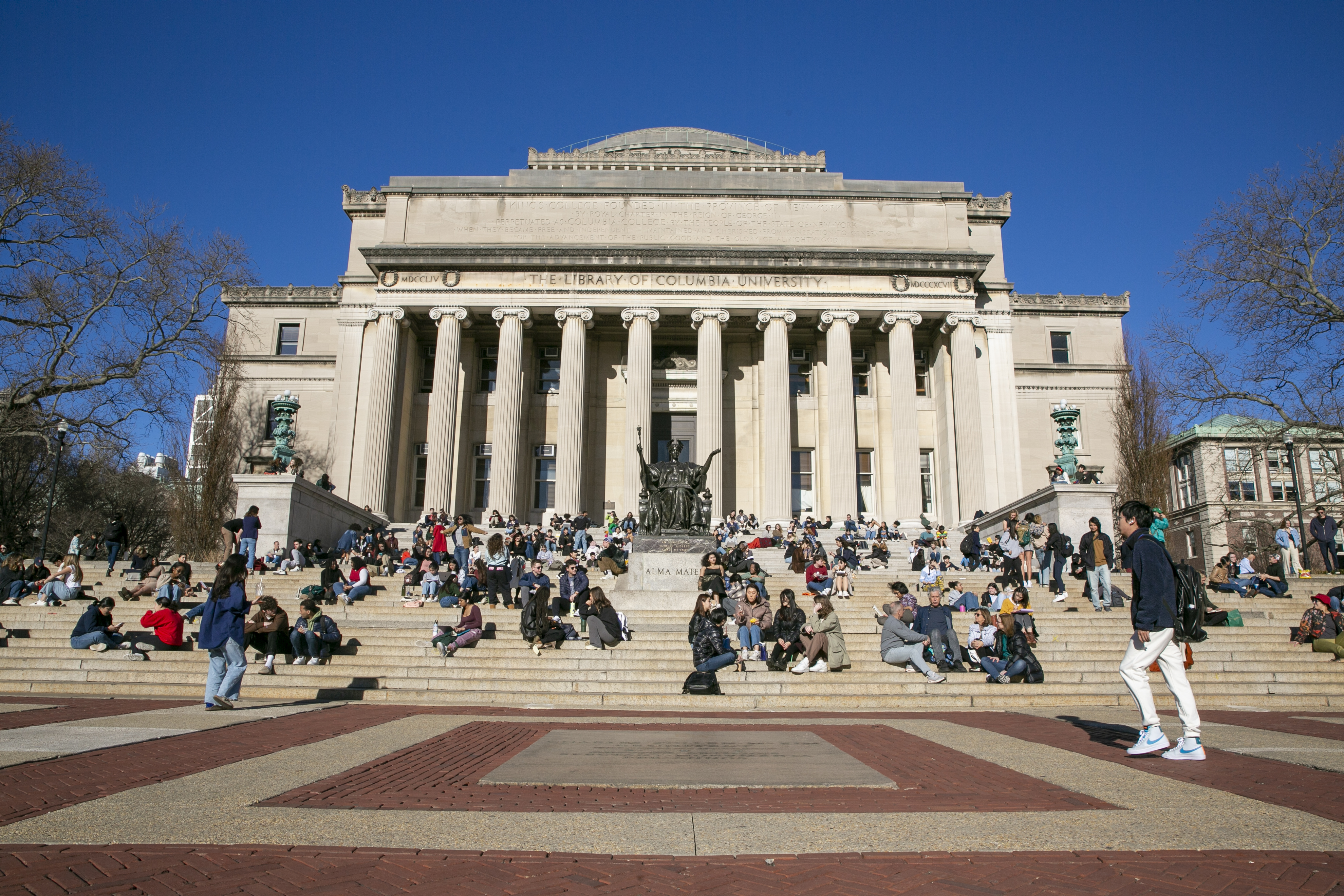 On an unseasonably warm day, students relax on the front steps of Low Memorial Library on the Columbia University campus in New York City on Friday, February 10, 2023. (AP Photo/Ted Shaffrey)