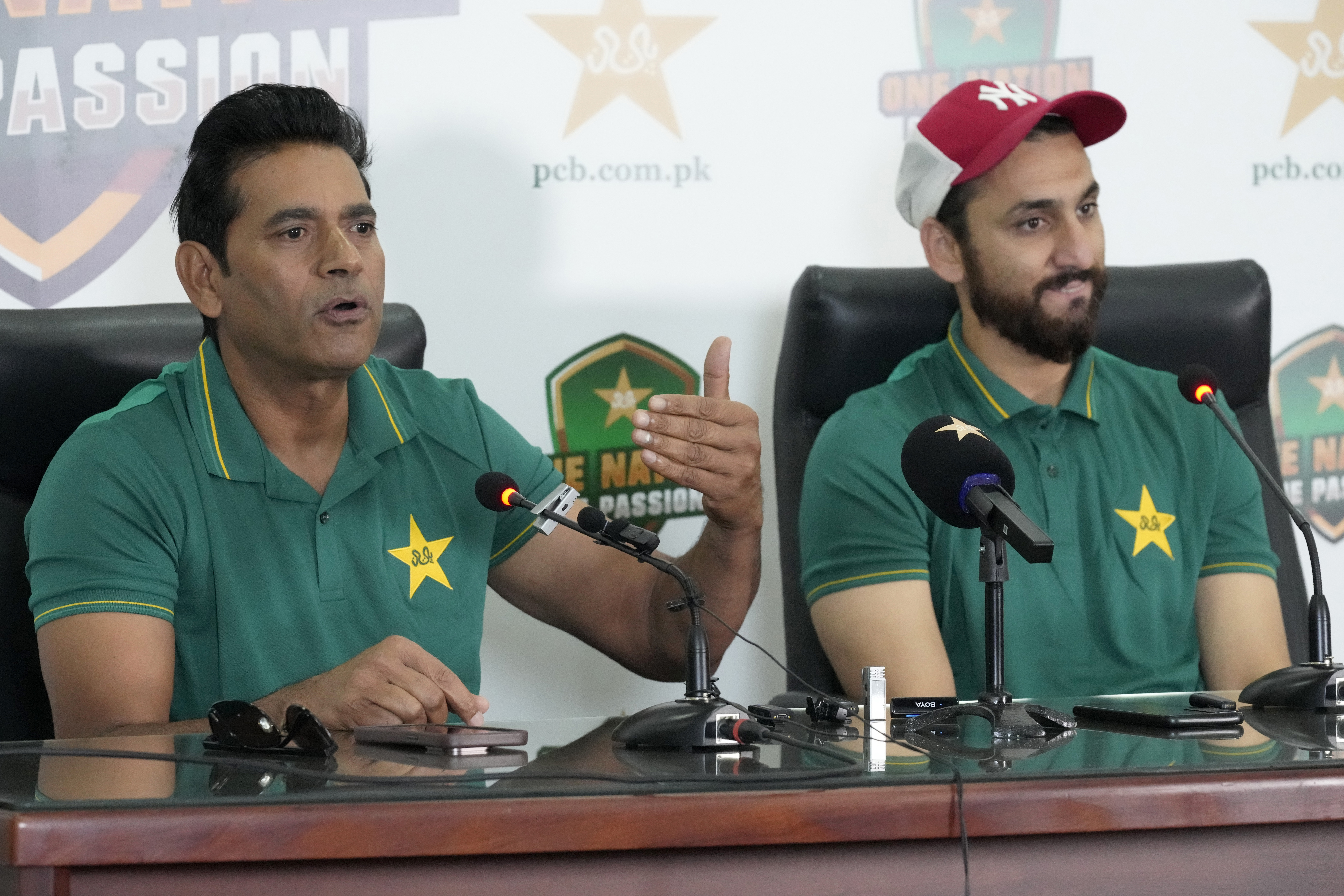 Pakistan interim head coach Aaqib Javed, left, speaks as Salman Ali Agha watches during a press conference to announce squad for upcoming New Zealand tour, in Lahore, Pakistan, Tuesday, March 4, 2025. (AP Photo/K.M Chaudary)