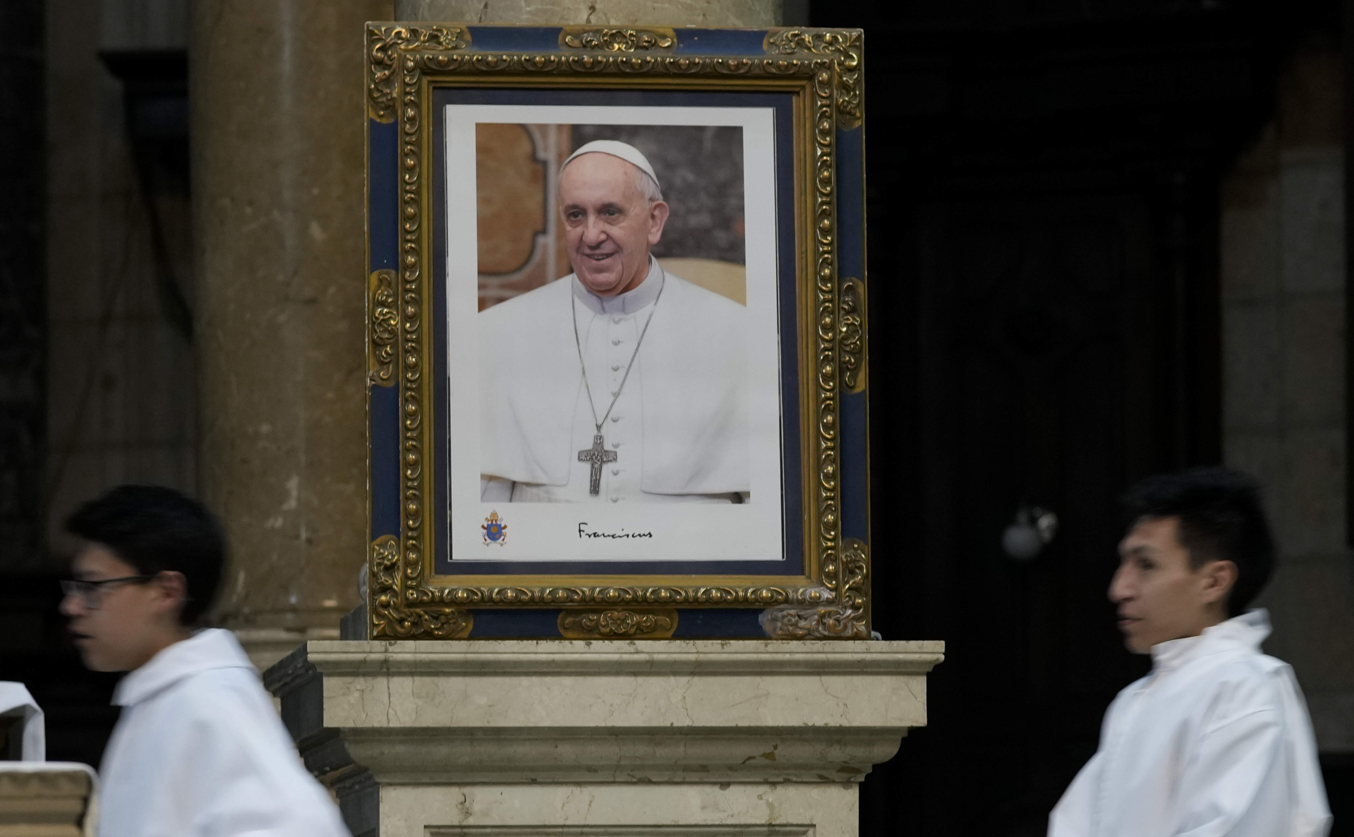 A photo of Pope Francis adorns a wall at a cathedral.