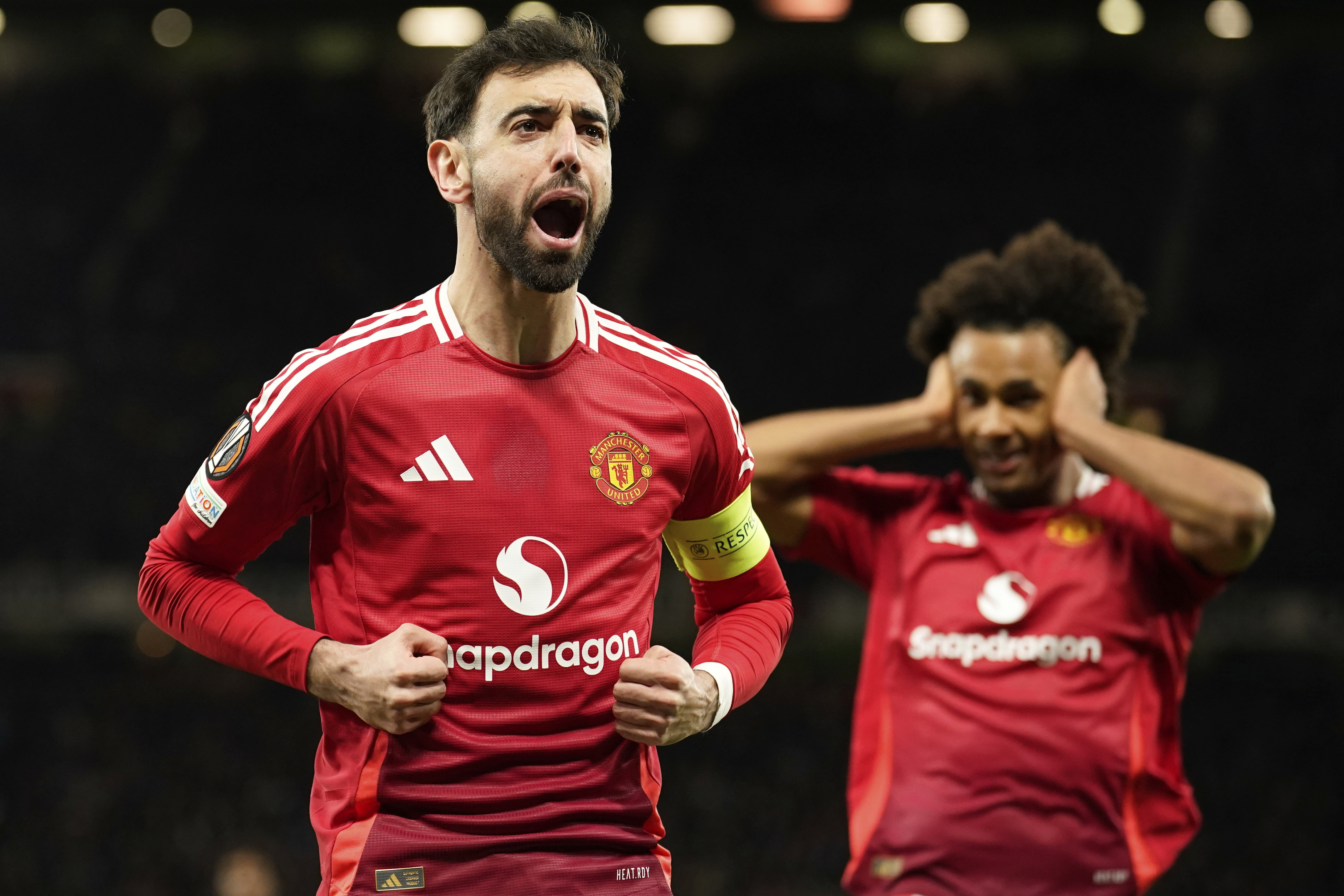 Manchester United's Bruno Fernandes celebrates scoring his side's first goal during the Europa League soccer match between Manchester United and Real Sociedad at Old Trafford stadium in Manchester, England, Thursday, March 13, 2025 . (AP Photo/Dave Thompson)