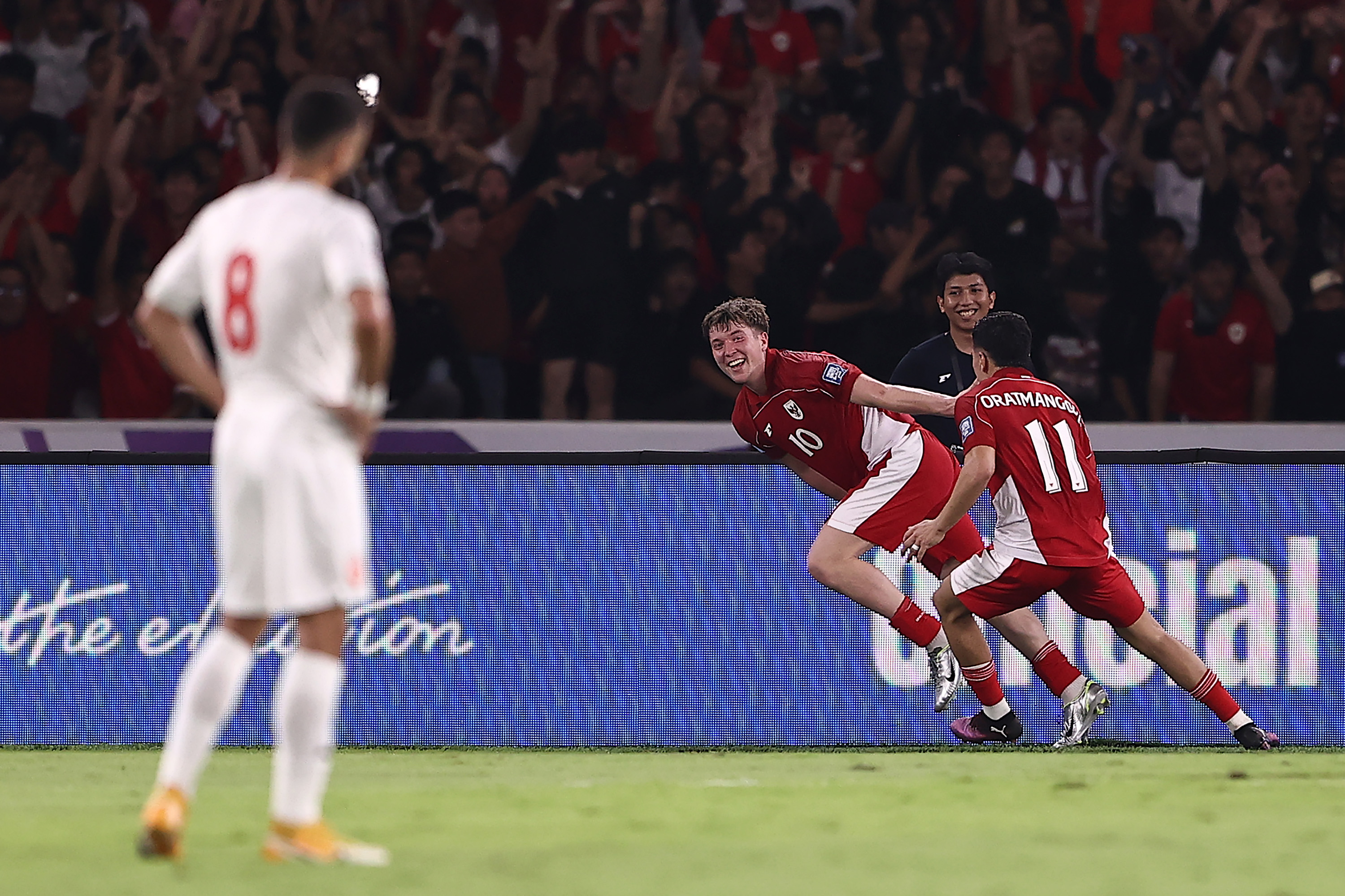 JAKARTA, INDONESIA - MARCH 25: Ole Romeny (C) of Indonesia celebrates with teammate Ragnar Oratmangoen (R) after scoring the team's first goal during the FIFA World Cup qualifier Asian third round Group C match between Indonesia and Bahrain at Gelora Bung Karno Stadium on March 25, 2025 in Jakarta, Indonesia. (Photo by Robertus Pudyanto/Getty Images)
