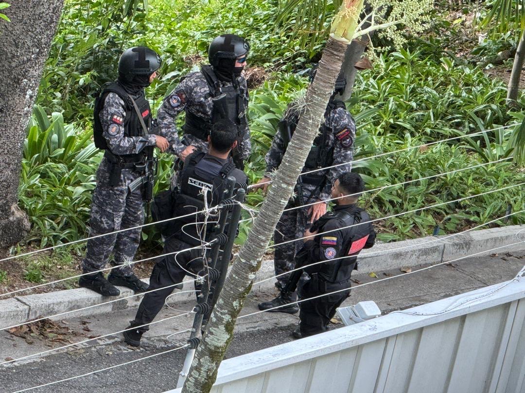 Security forces in tactical gear stand outside the Argentine embassy in Caracas