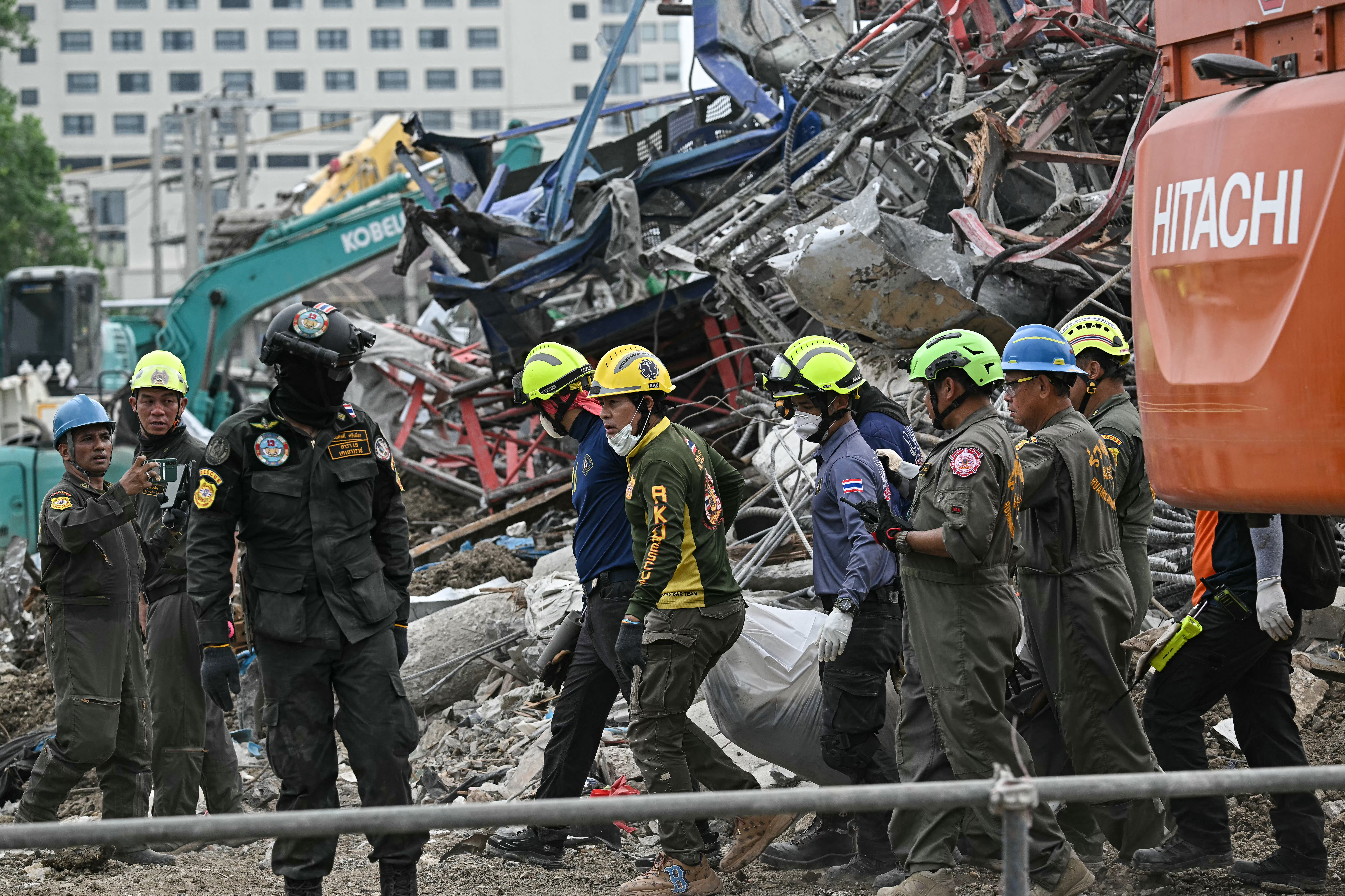 Rescue workers carry the body of a victim at the site of an under-construction building collapse in Bangkok on March 30, 2025, two days after an earthquake struck central Myanmar and Thailand.