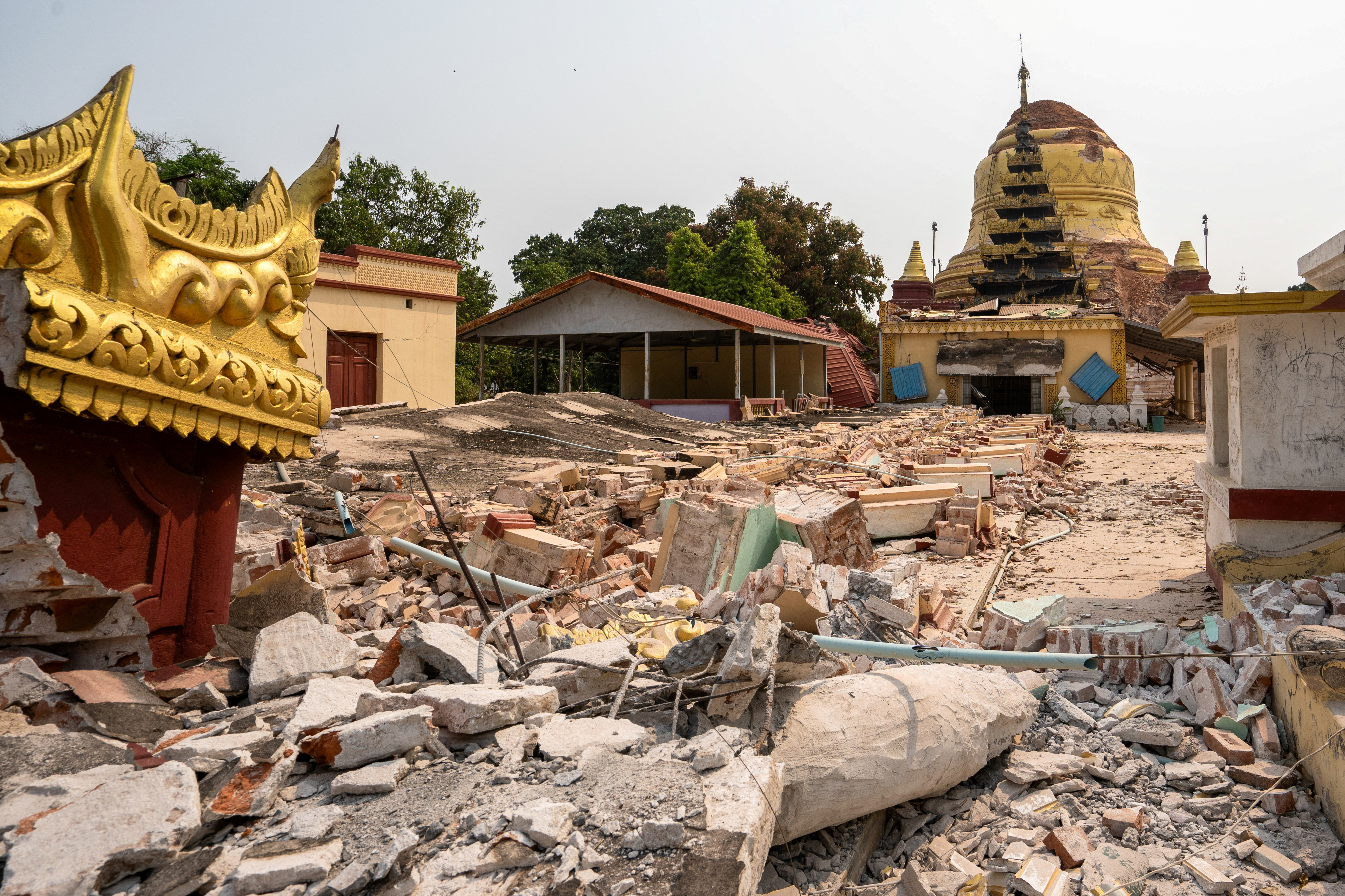 Rubble lies near a damaged pagoda.