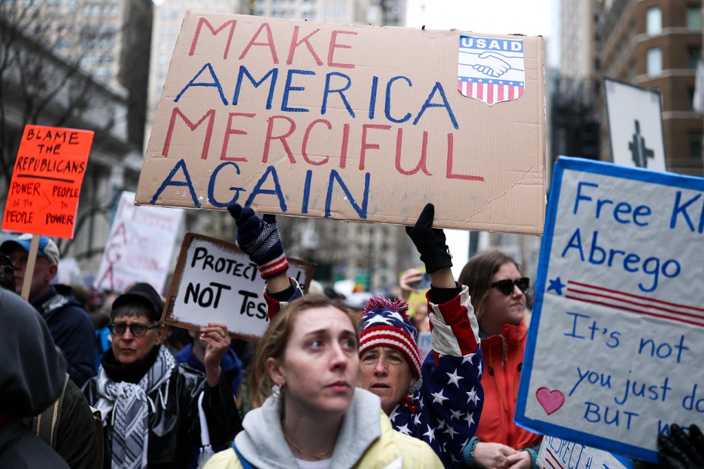 Demonstrators march during the nationwide "Hands Off!" protest against US President Donald Trump and his advisor, Tesla CEO Elon Musk, in New York on April 5, 2025.