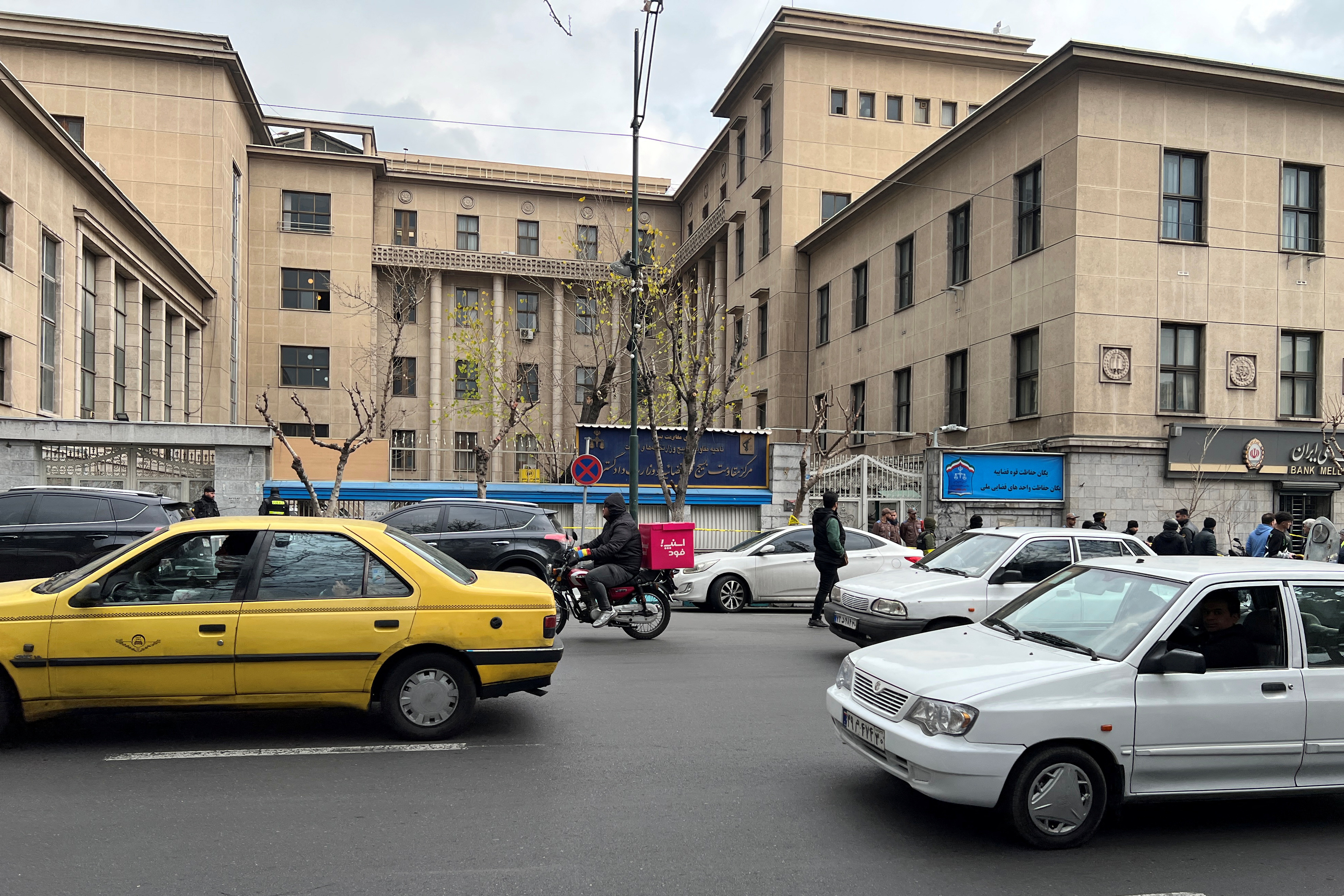 Members of the police stand in front of the judiciary building