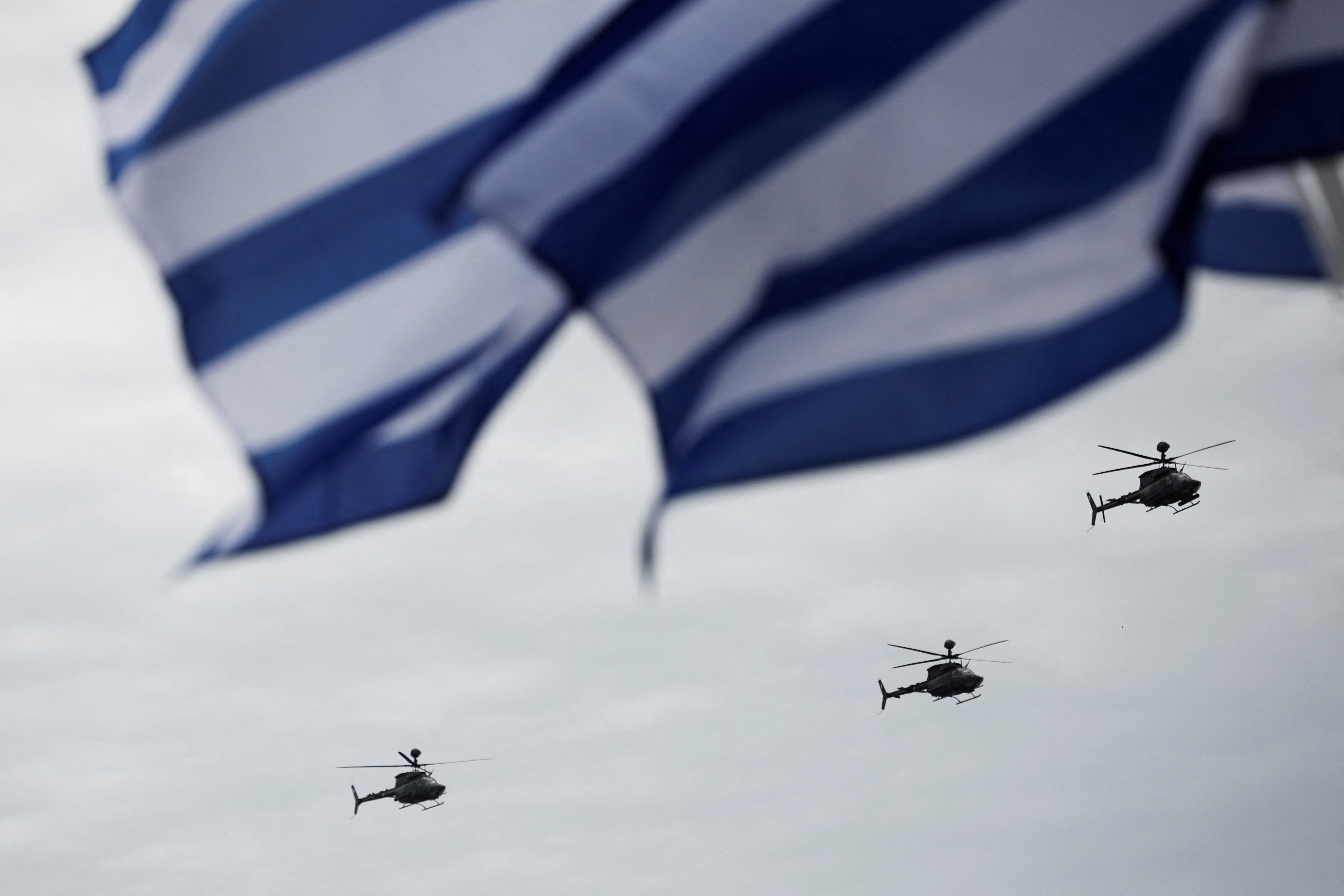 Kiowa helicopters fly during a military parade marking Greece's Independence Day, in Athens, Greece, March 25, 2025. REUTERS/Louiza Vradi