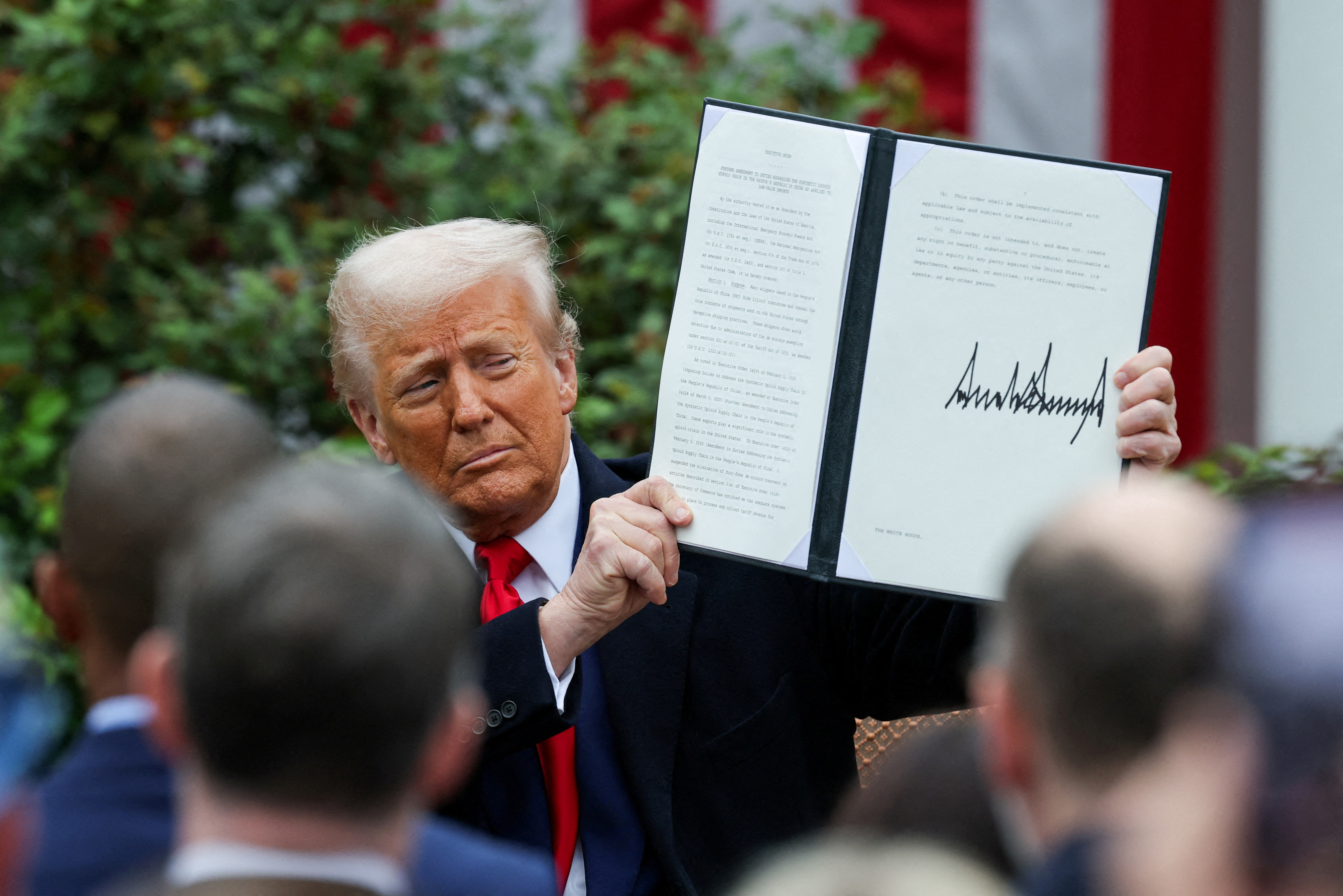 US President Donald Trump holds a signed executive order, on the day he delivers remarks on tariffs in the Rose Garden at the White House in Washington, DC, US, April 2, 2025. [Carlos Barria/Reuters]