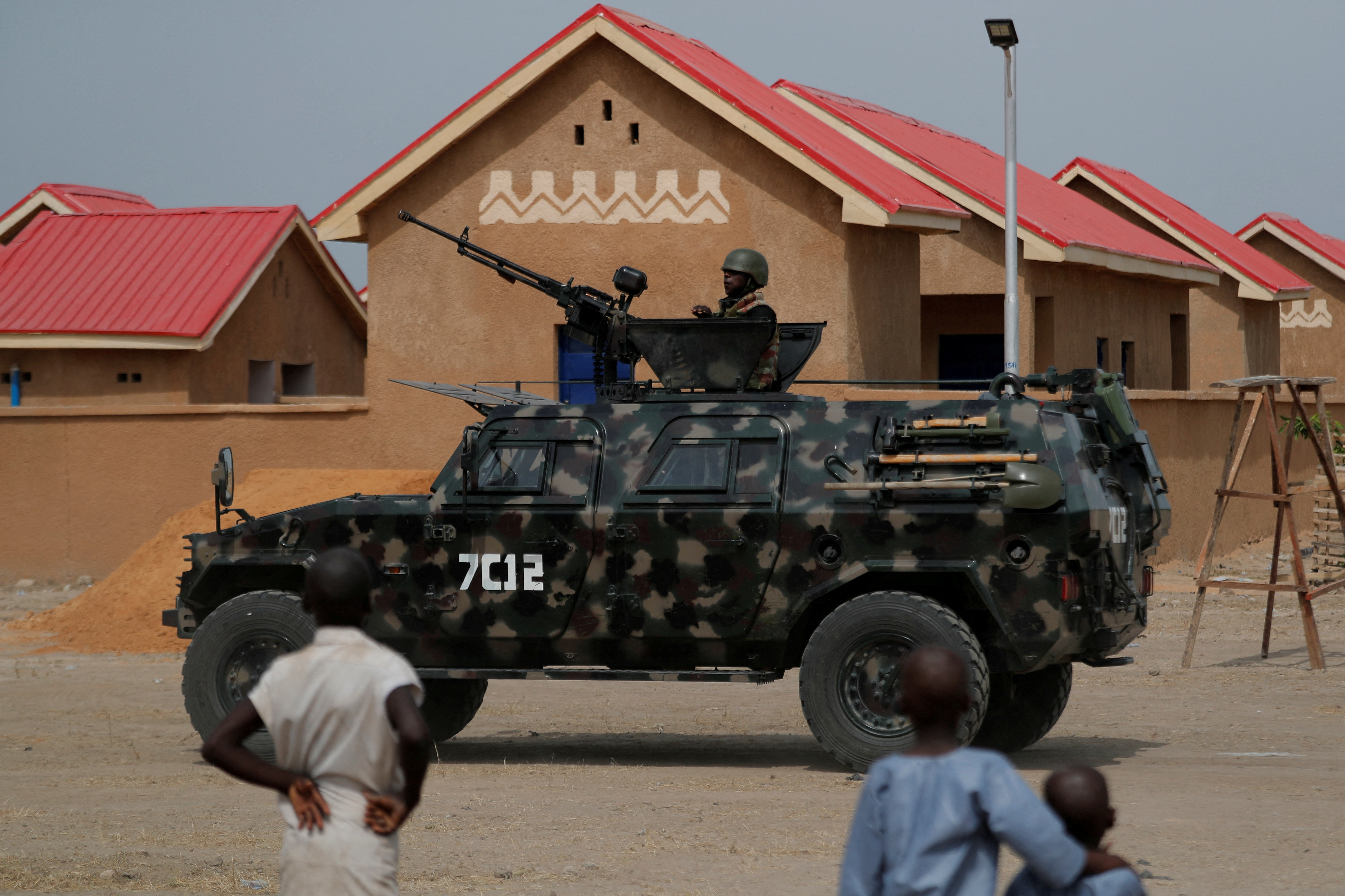 FILE PHOTO: An armored vehicle of Nigerian Security Forces drives by newly built homes.
