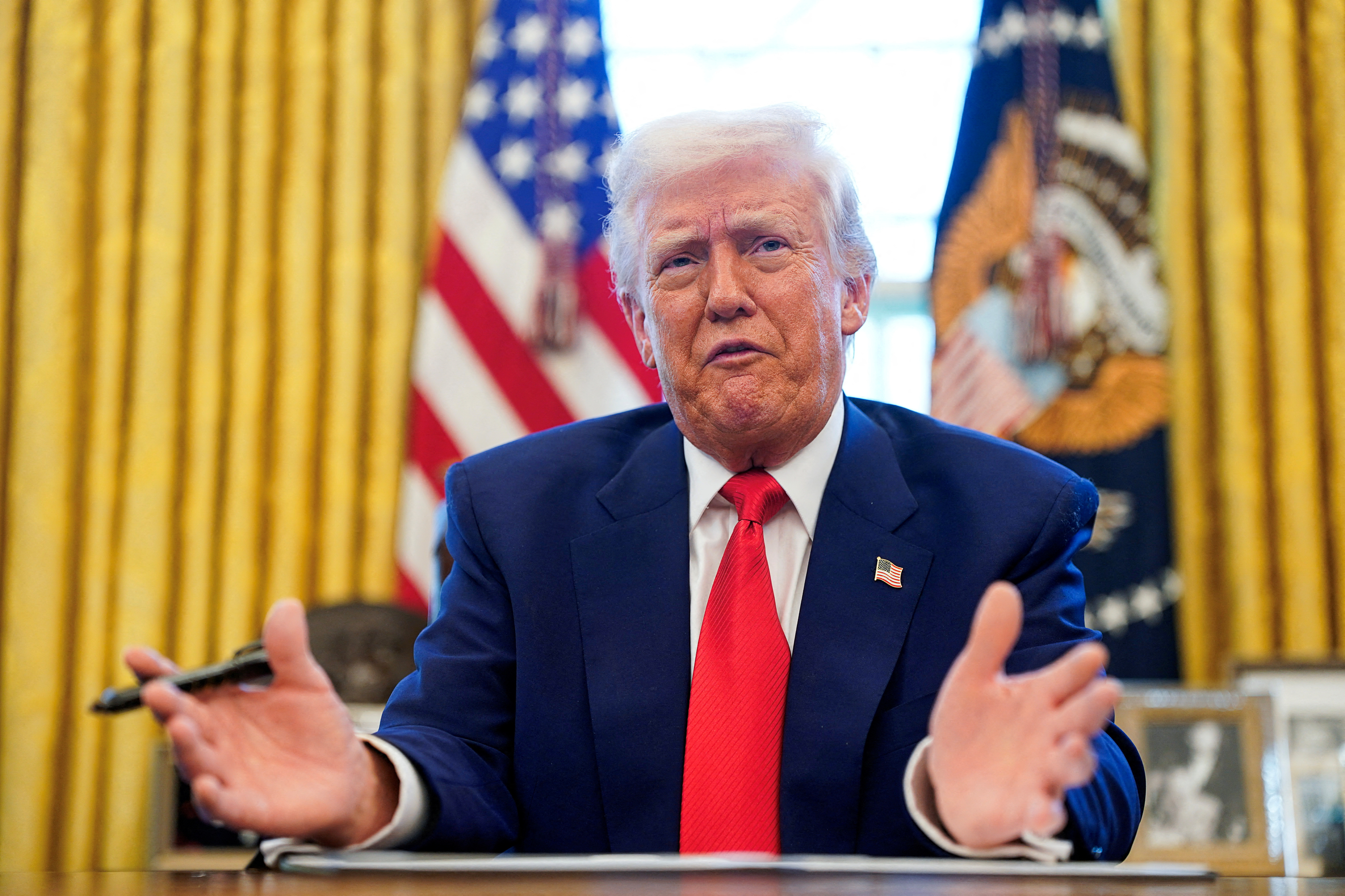 FILE PHOTO: U.S. President Donald Trump speaks, as he signs executive orders and proclamations in the Oval Office at the White House in Washington, D.C., U.S., April 9, 2025. REUTERS/Nathan Howard/File Photo