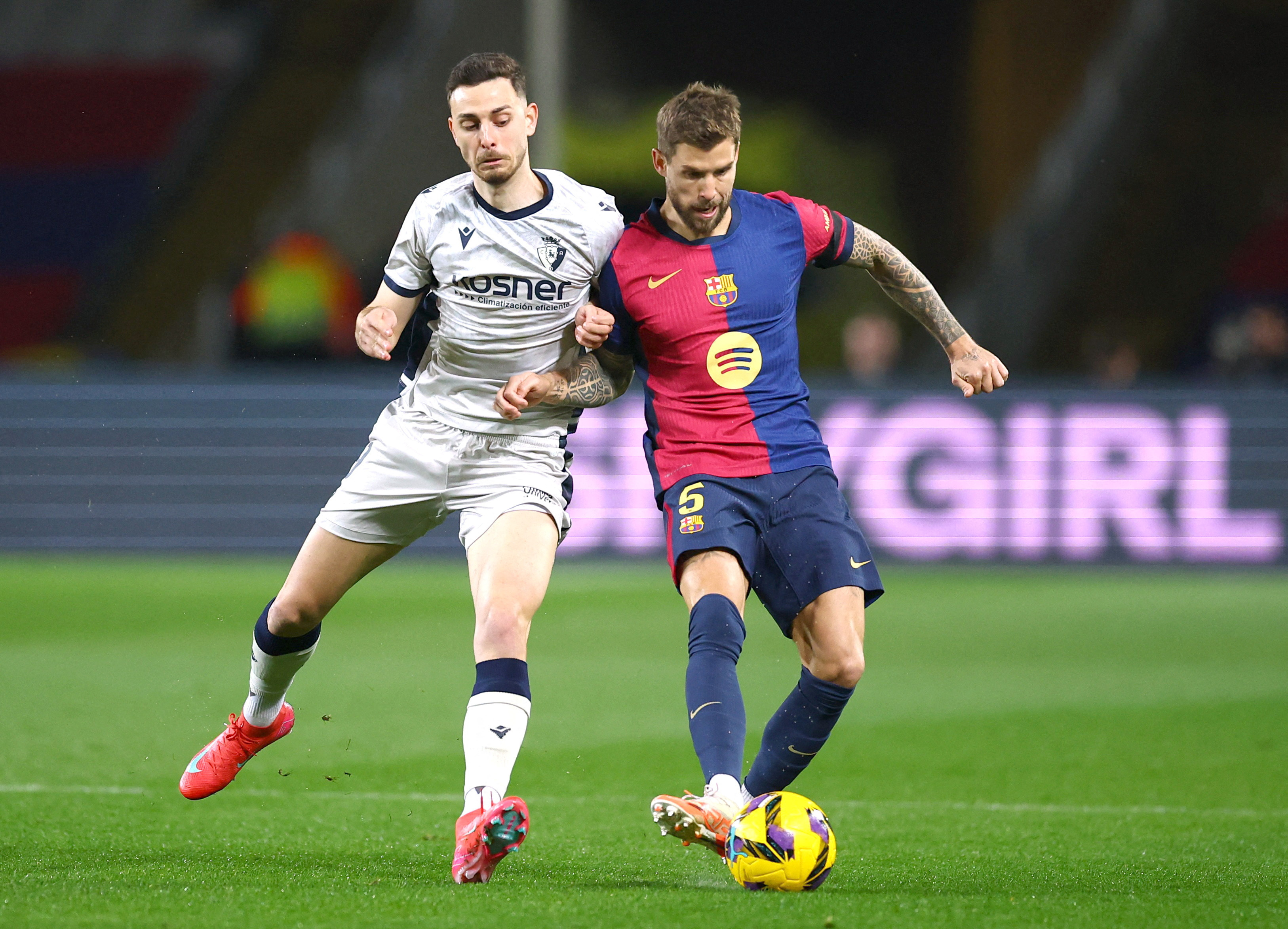 FC Barcelona's Inigo Martinez in action with Osasuna's Raul Garcia.