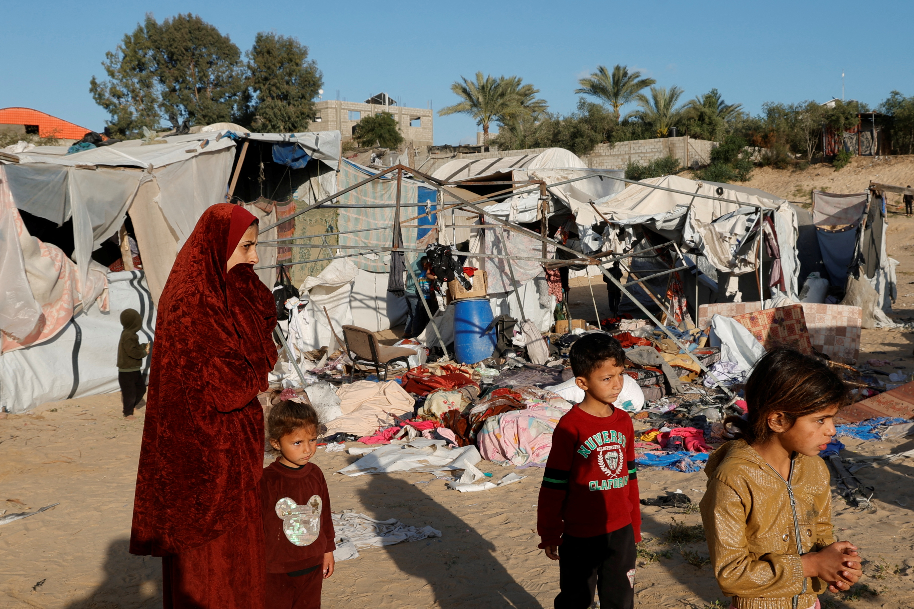 Palestinians inspect the damage at the site of an Israeli strike on a tent sheltering displaced people, in Khan Younis in the southern Gaza Strip April 15, 2025. REUTERS/Hatem Khaled