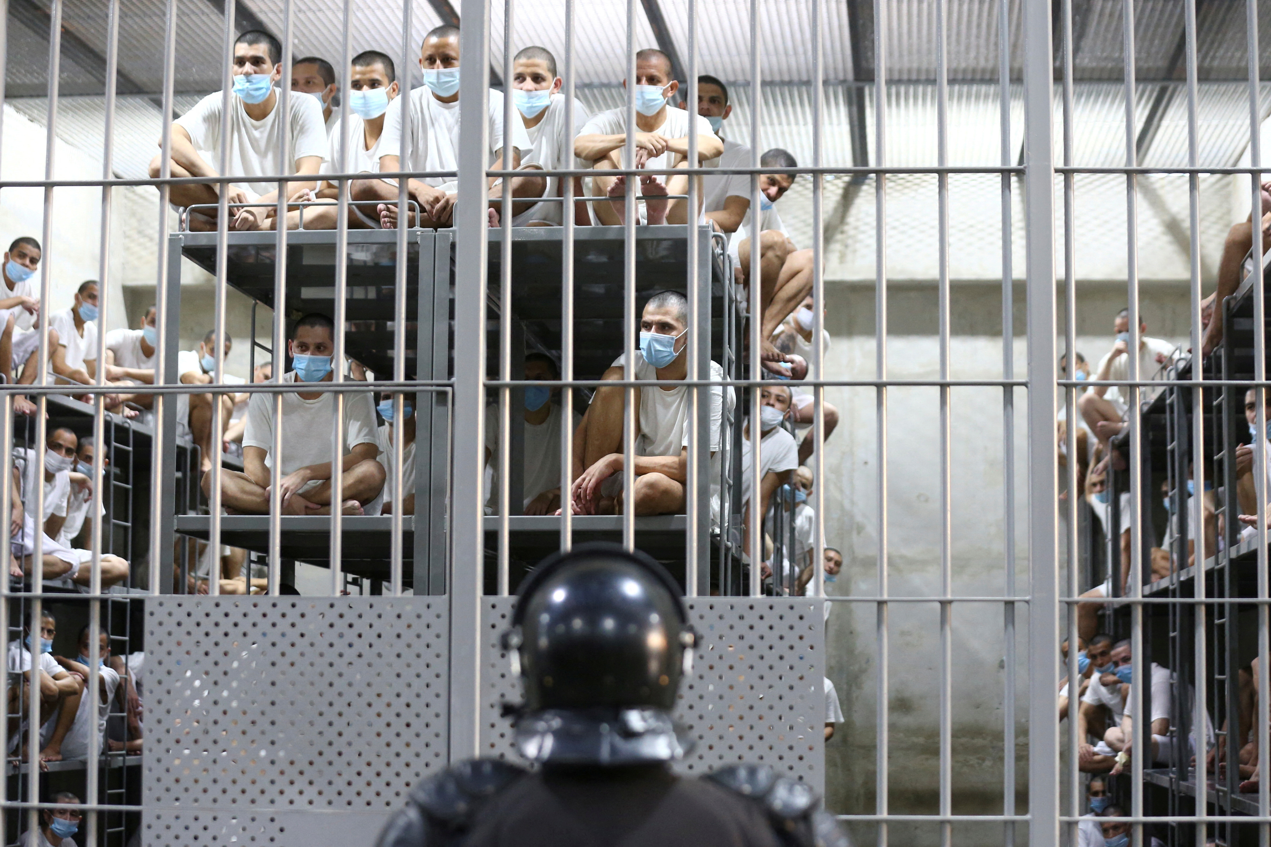 Inmates look on inside a jail during a media tour at the Terrorism Confinement Center (CECOT) prison, in Tecoluca, El Salvador April 4, 2025.