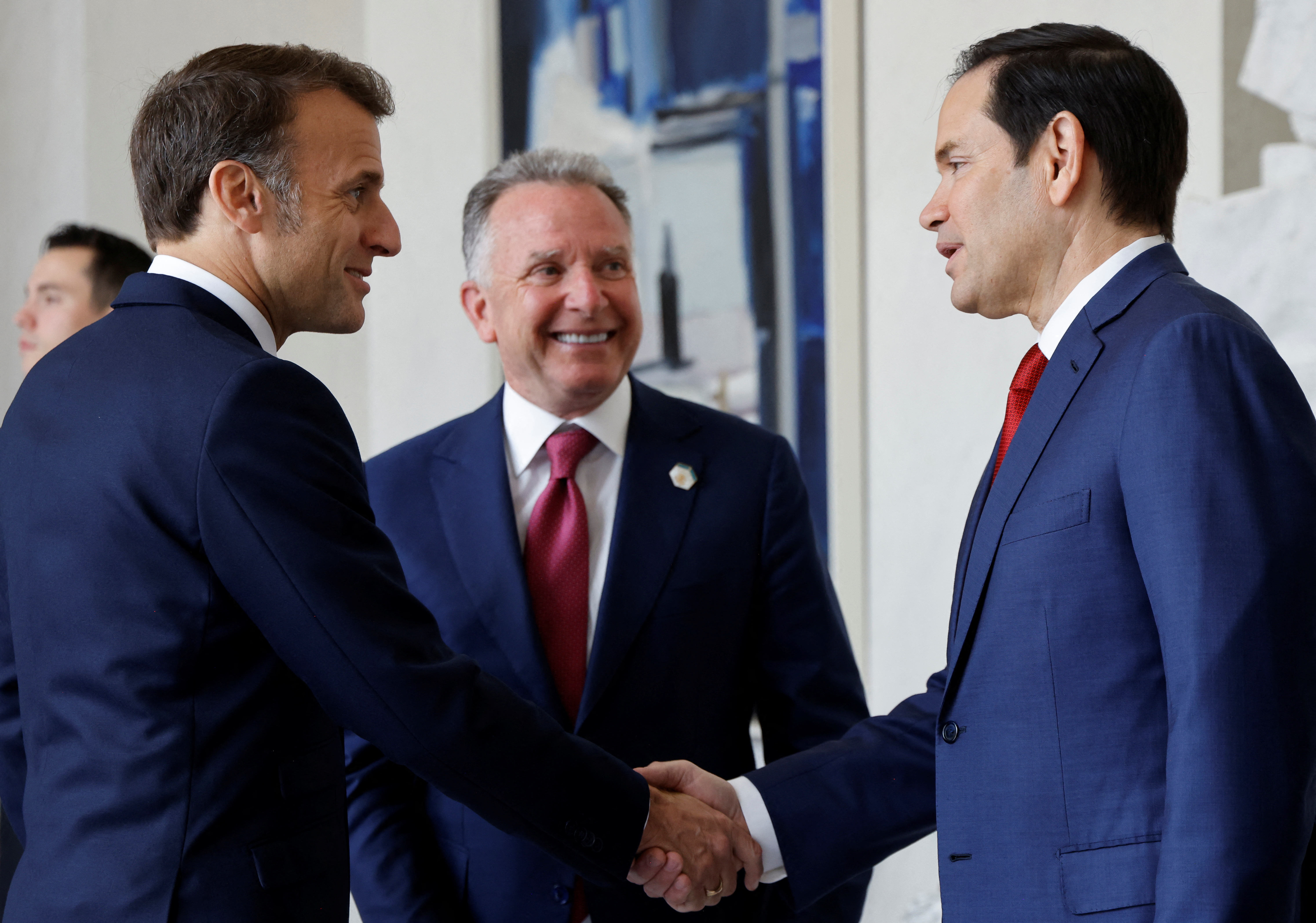 Emmanuel Macron shakes hands with US Secretary of State Marco Rubio as US envoy Steve Witkoff looks on
