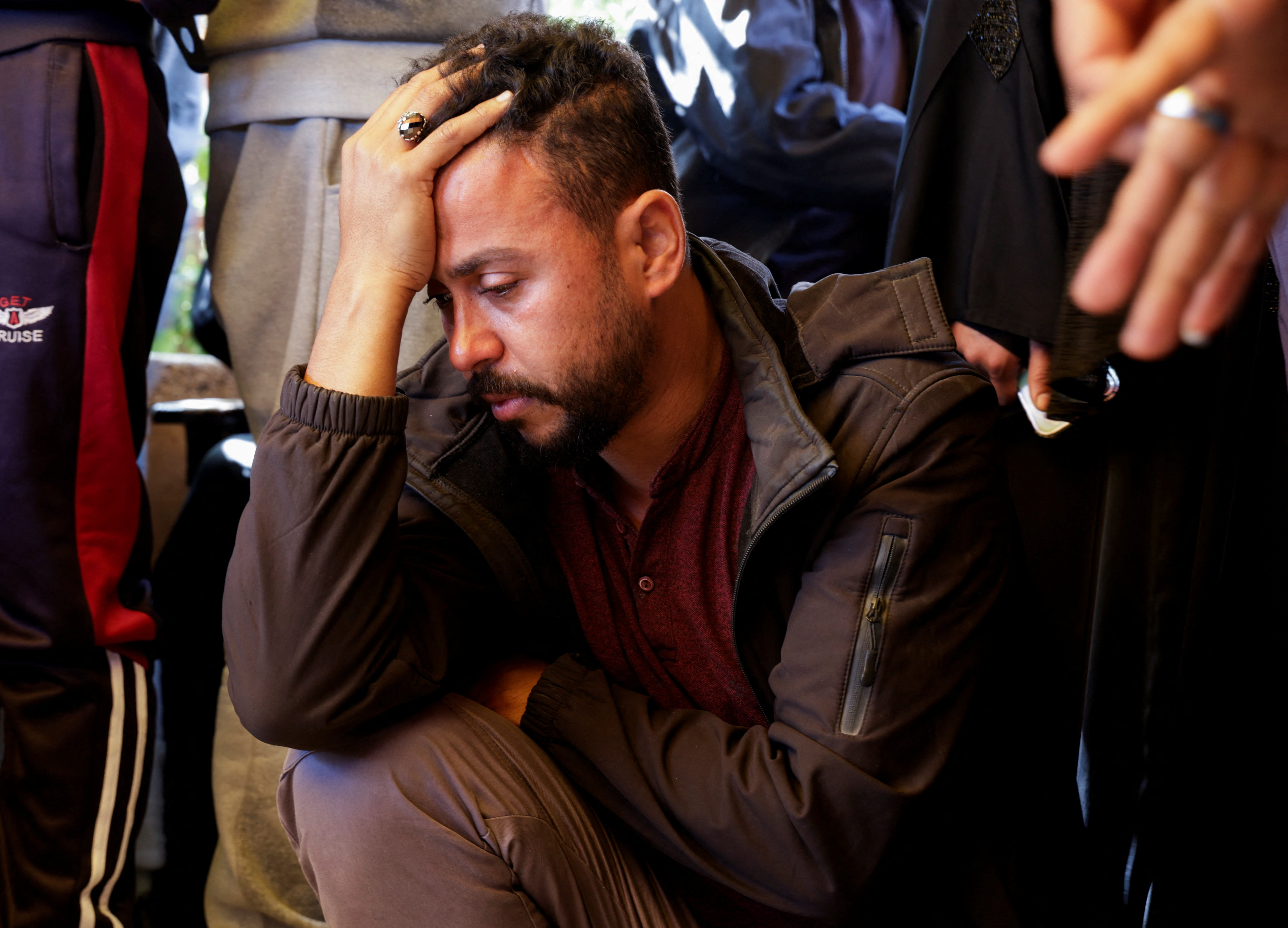 A man mourns near the bodies of Palestinians killed in Israeli attacks.