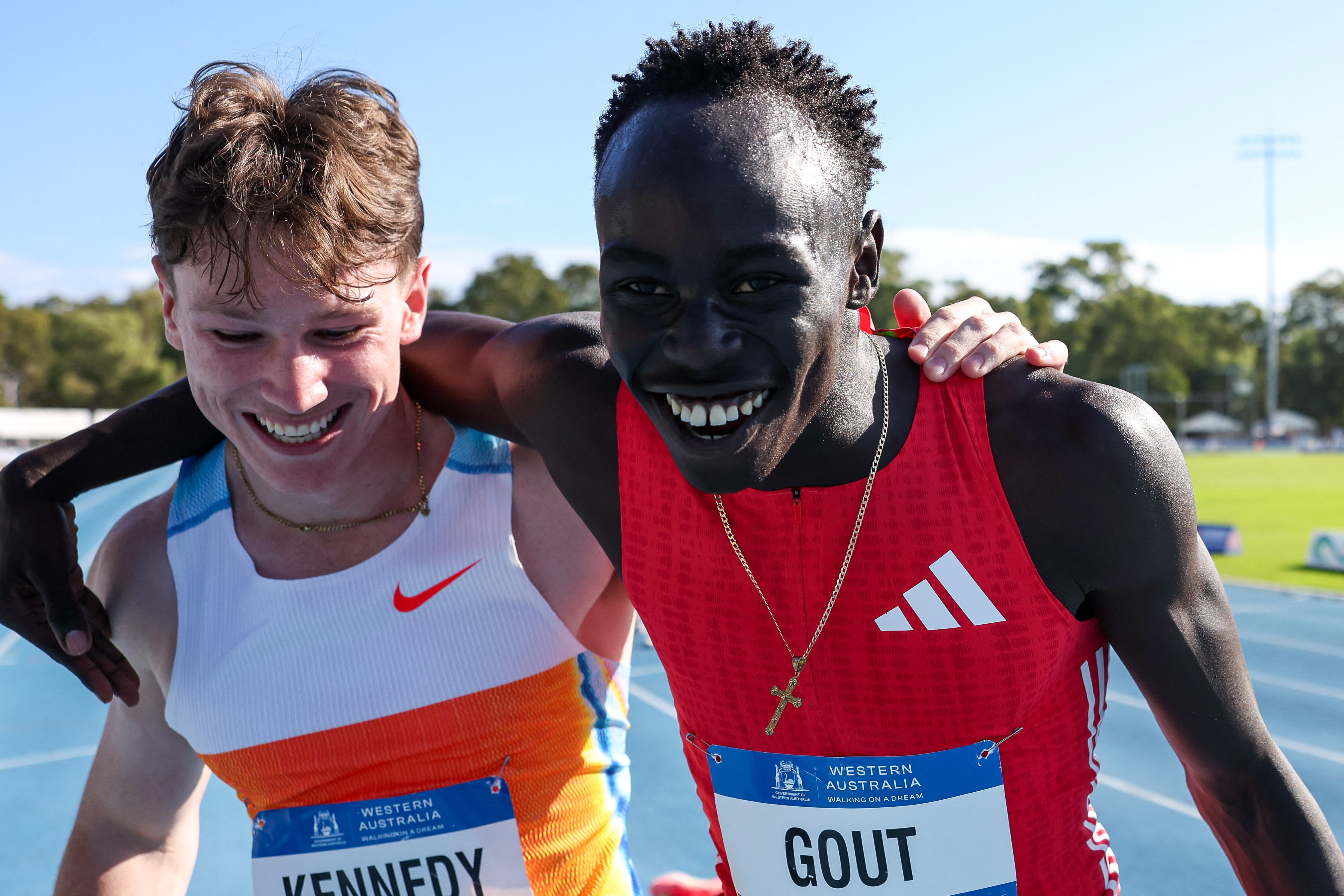 Australia's Gout Gout (R) celebrates winning the men's 200m final, with Australia's Lachlan Kennedy, who was disqualified earlier, during the Australian Athletics Championships in Perth on April 13, 2025. (Photo by COLIN MURTY / AFP) / -- IMAGE RESTRICTED TO EDITORIAL USE - STRICTLY NO COMMERCIAL USE --
