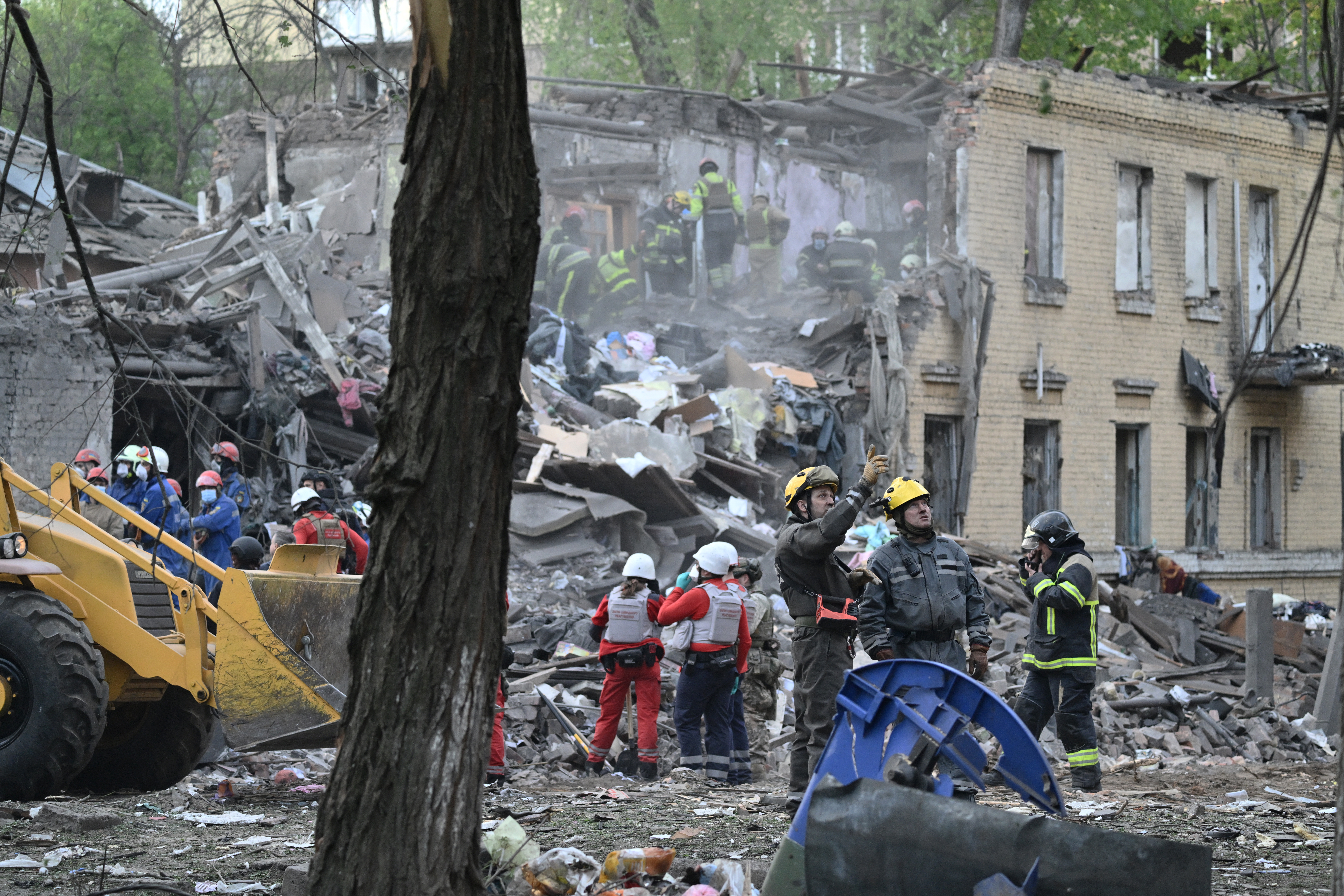 Ukrainian rescuers operate at the site of a Russian missile attack in Kyiv.