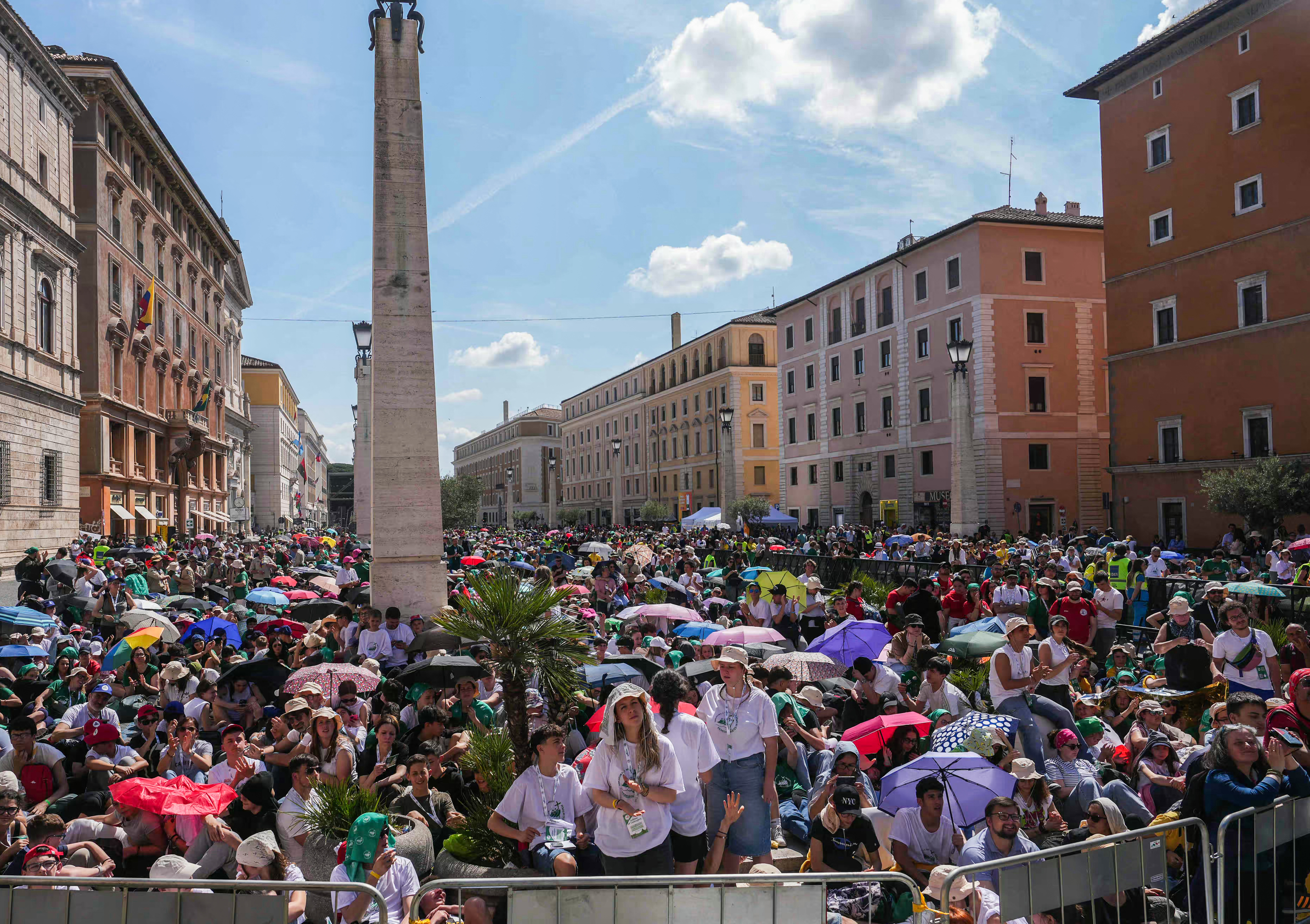 Faithful shade from the sun, with umbrellas as they attend a holy mass a day after the funeral of Pope Francis