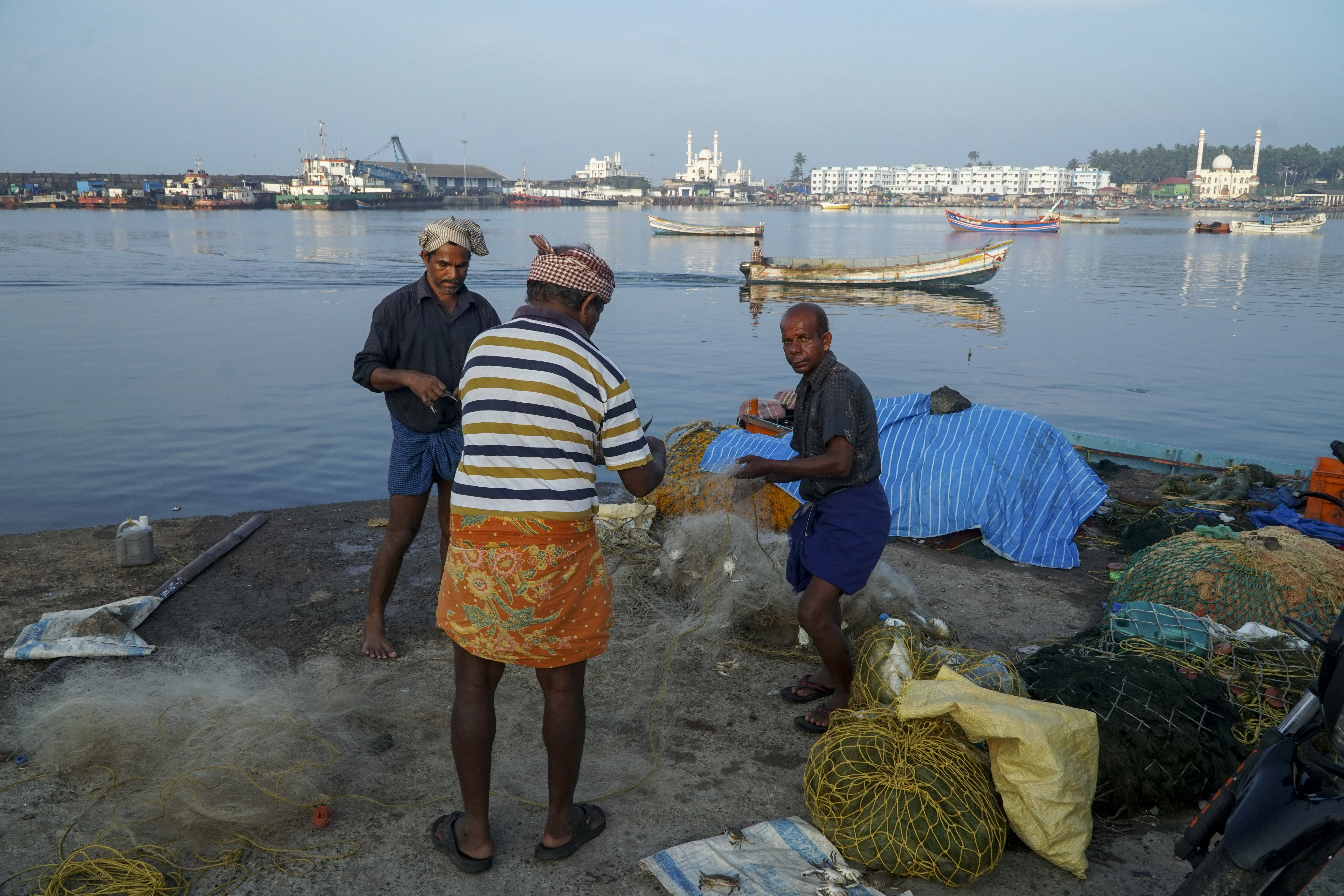 Fishermen clear their nets in the morning at Vizhinjam on the Arabian Sea coast in Kerala, India, Tuesday, Dec.6, 2022. (AP Photo)