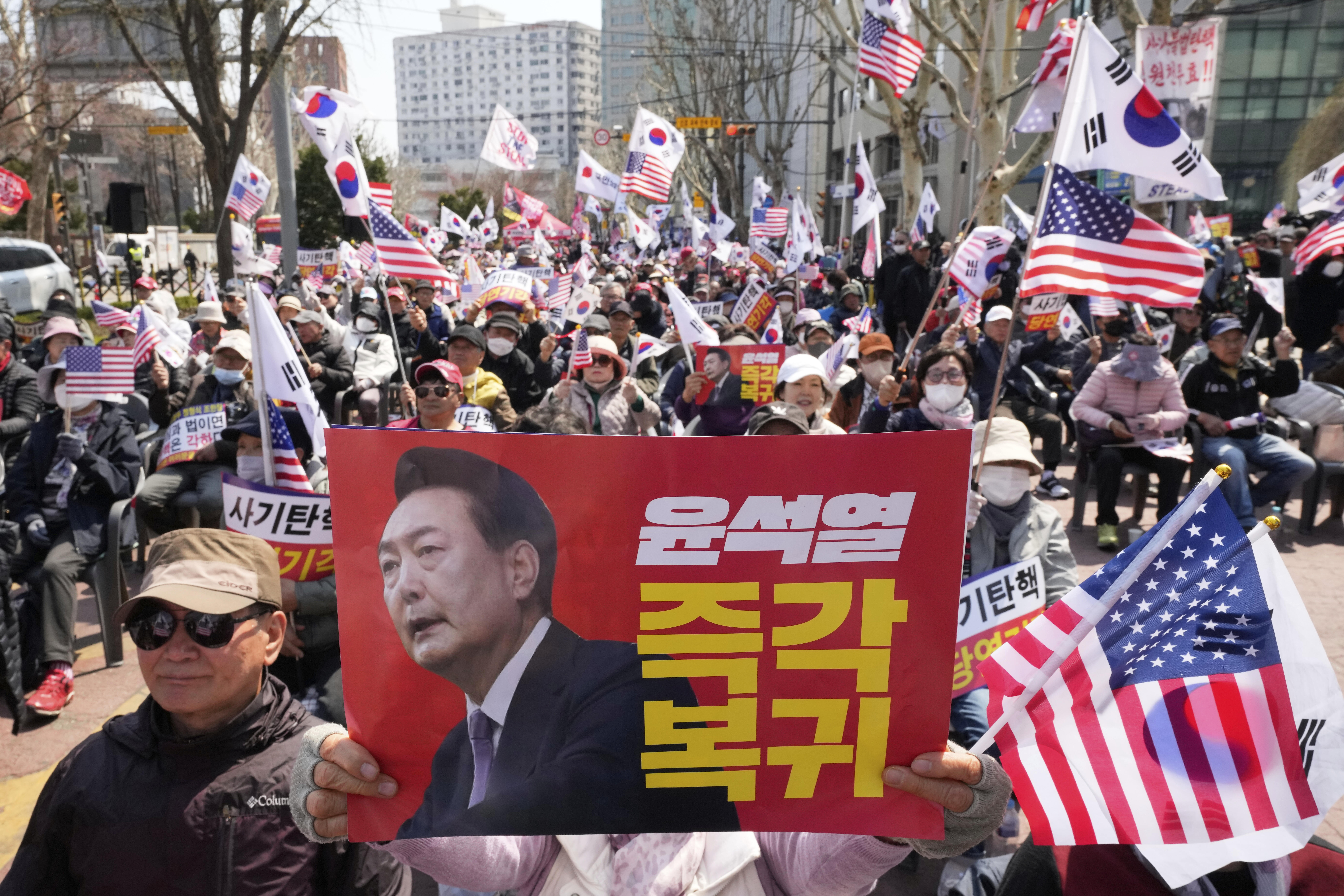 Supporters of impeached South Korean President Yoon Suk Yeol stage a rally to oppose his impeachment near the Constitutional Court in Seoul, South Korea, Thursday, April 3, 2025. The letters read "Yoon Suk Yeol's immediate return." (AP Photo/Ahn Young-joon)