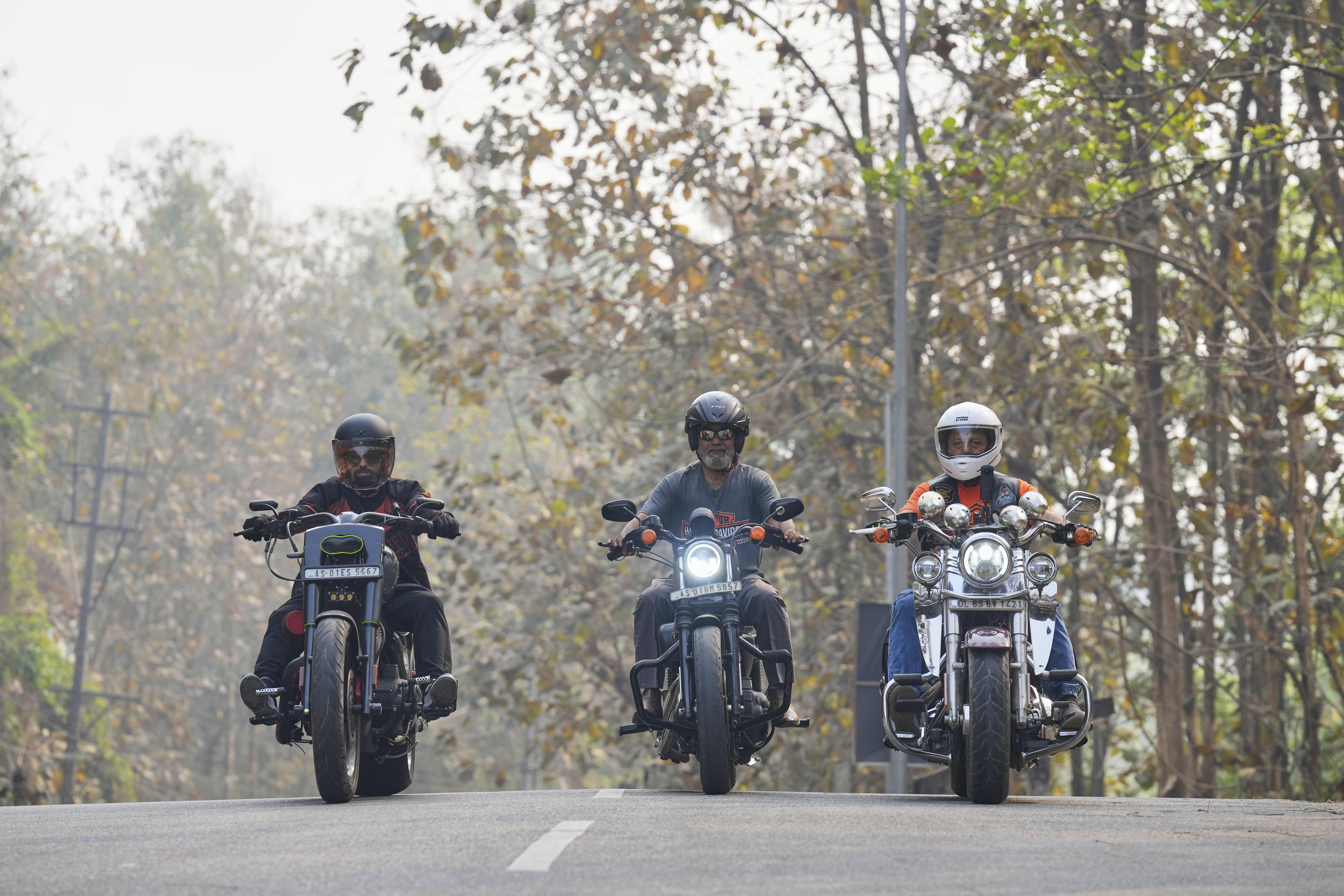 Indian bikers Abbasuddin Ahmed, center, flanked by Ripon Basak, left, and Arup Pathak ride their Harley Davidson motorbikes in Guwahati, India, Thursday, April 3, 2025. (AP Photo/Anupam Nath)