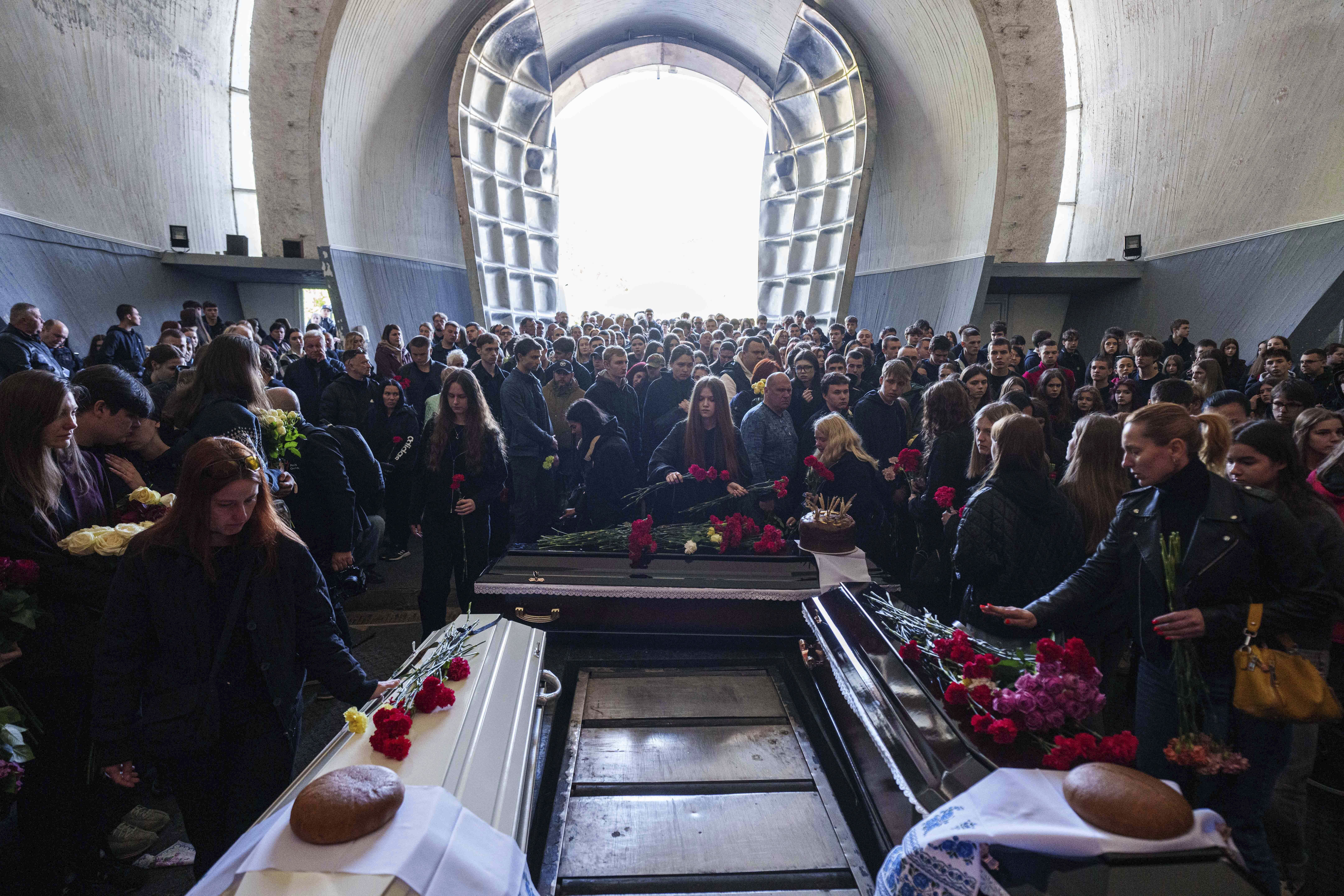 Friends and relatives attend the funeral service of teenager Danylo Khudia, and his parents Viktoria and Oleh Khudia, killed in a Russian strike on a residential neighbourhood on April 24, during a farewell ceremony at the crematorium in Kyiv, Ukraine, Monday, April 28, 2025. (AP Photo/Evgeniy Maloletka)