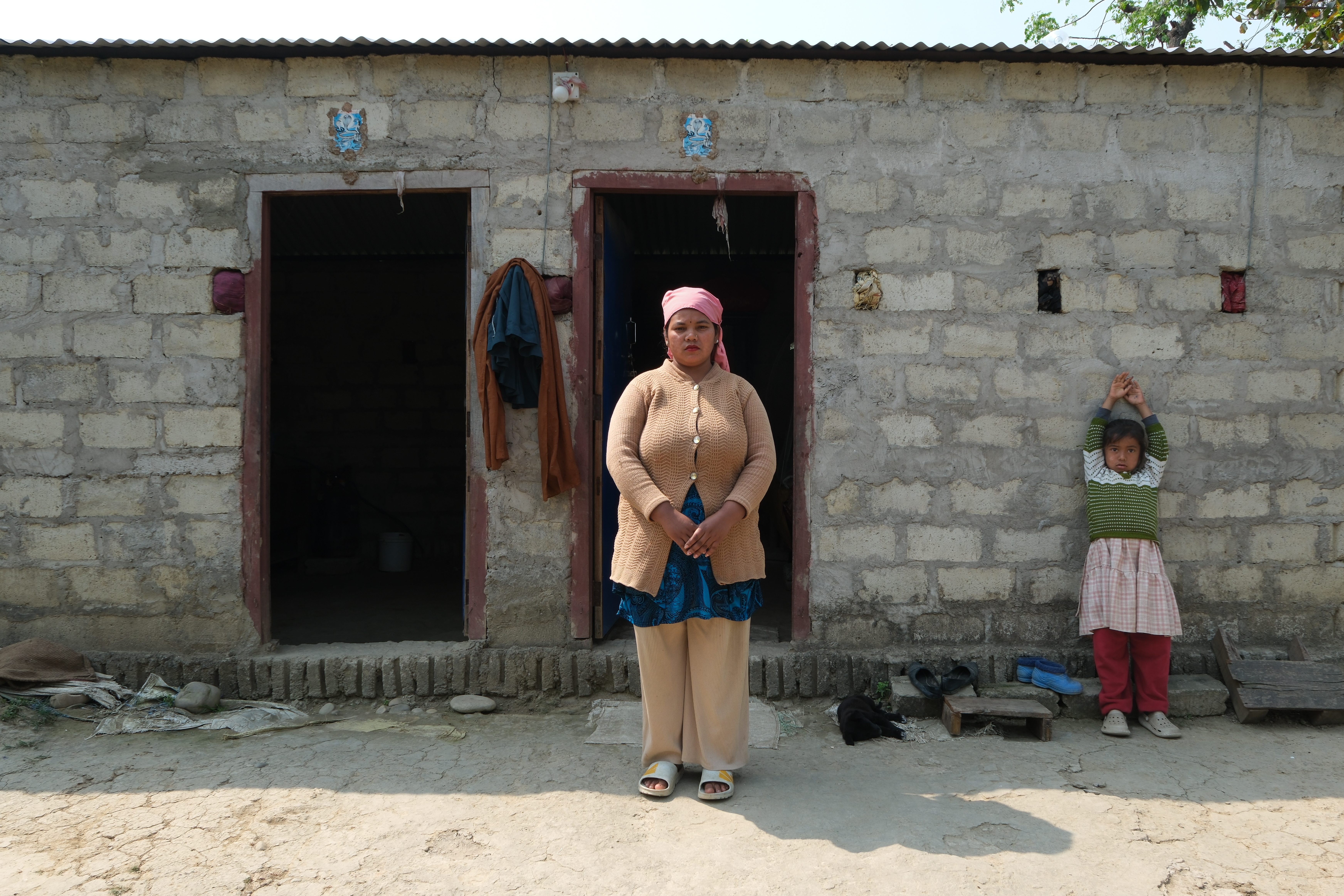 Anjali in front of the house she has built for her daughter and her, by taking out a loan. To her, this is "a palace" [Mirja Vogel/Al Jazeera]