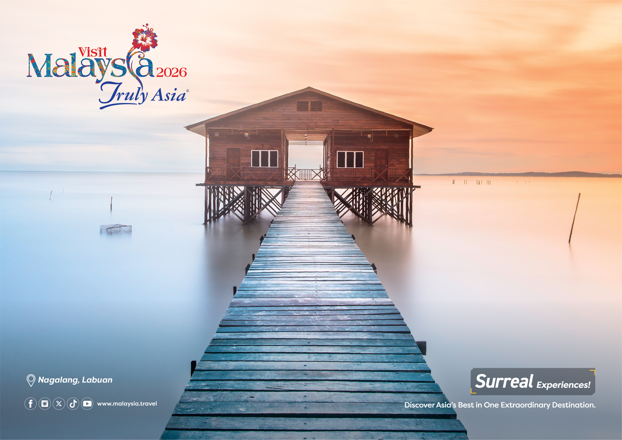 A wooden deck over water leads to a wooden building on stilts over the water