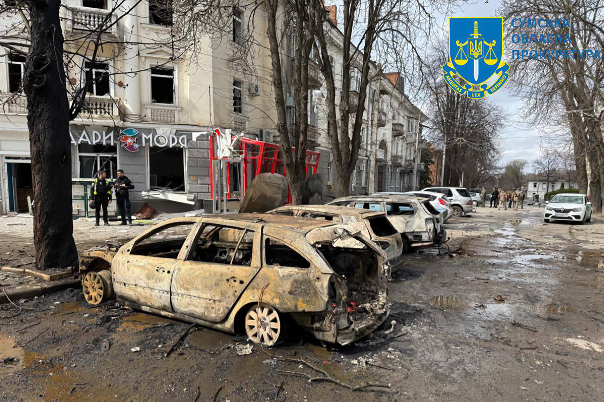 This handout photograph taken and released by Ukraine's Sumy Region Prosecutor's Office on April 13, 2025, shows burnt-out cars at the site of a missile attack in Sumy, northeastern Ukraine, amid the Russian invasion of Ukraine.
