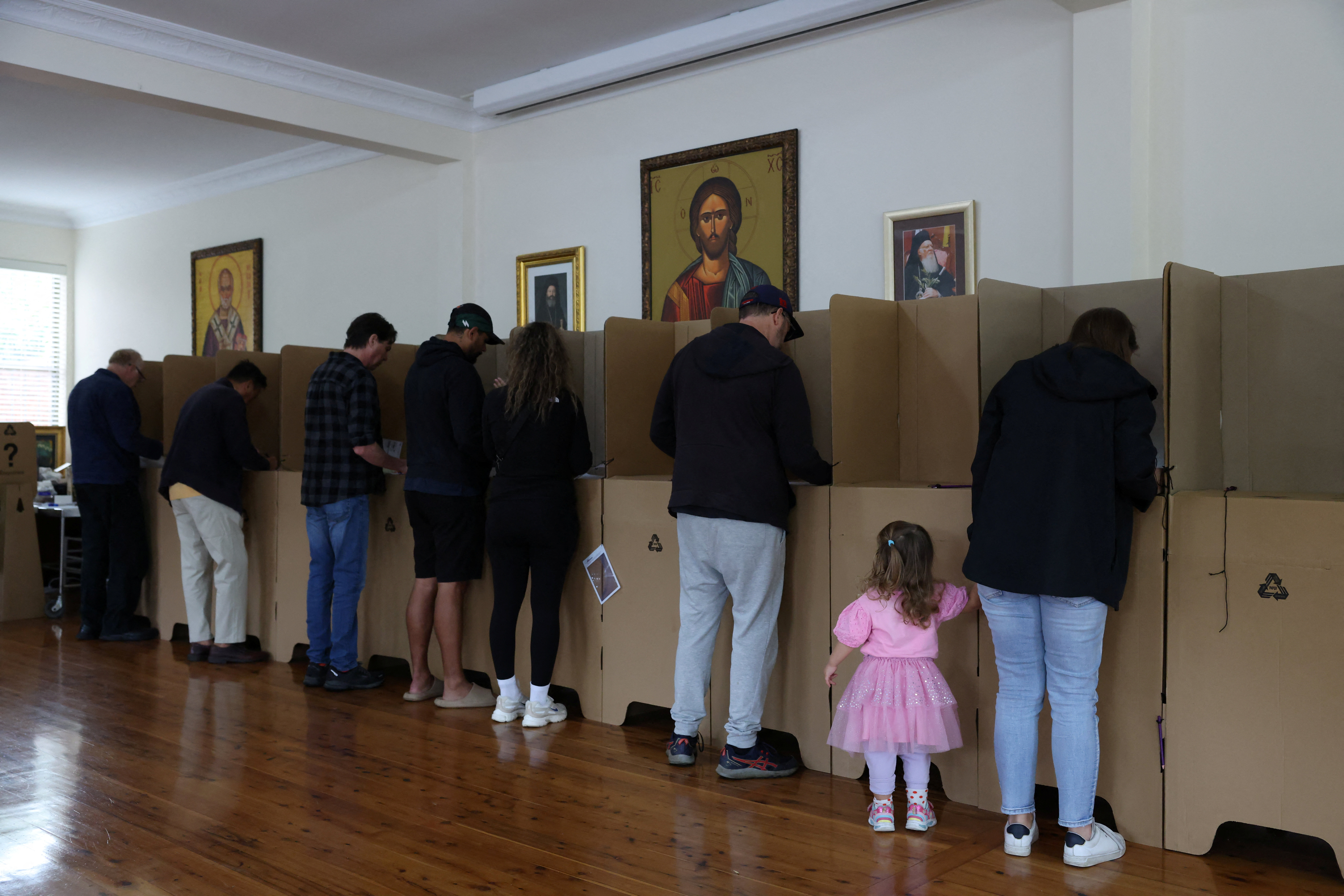 People vote at a pre-polling place inside a Greek Orthodox Church in the lead up to the Australian federal election in Sydney, Australia, April 30, 2025.
