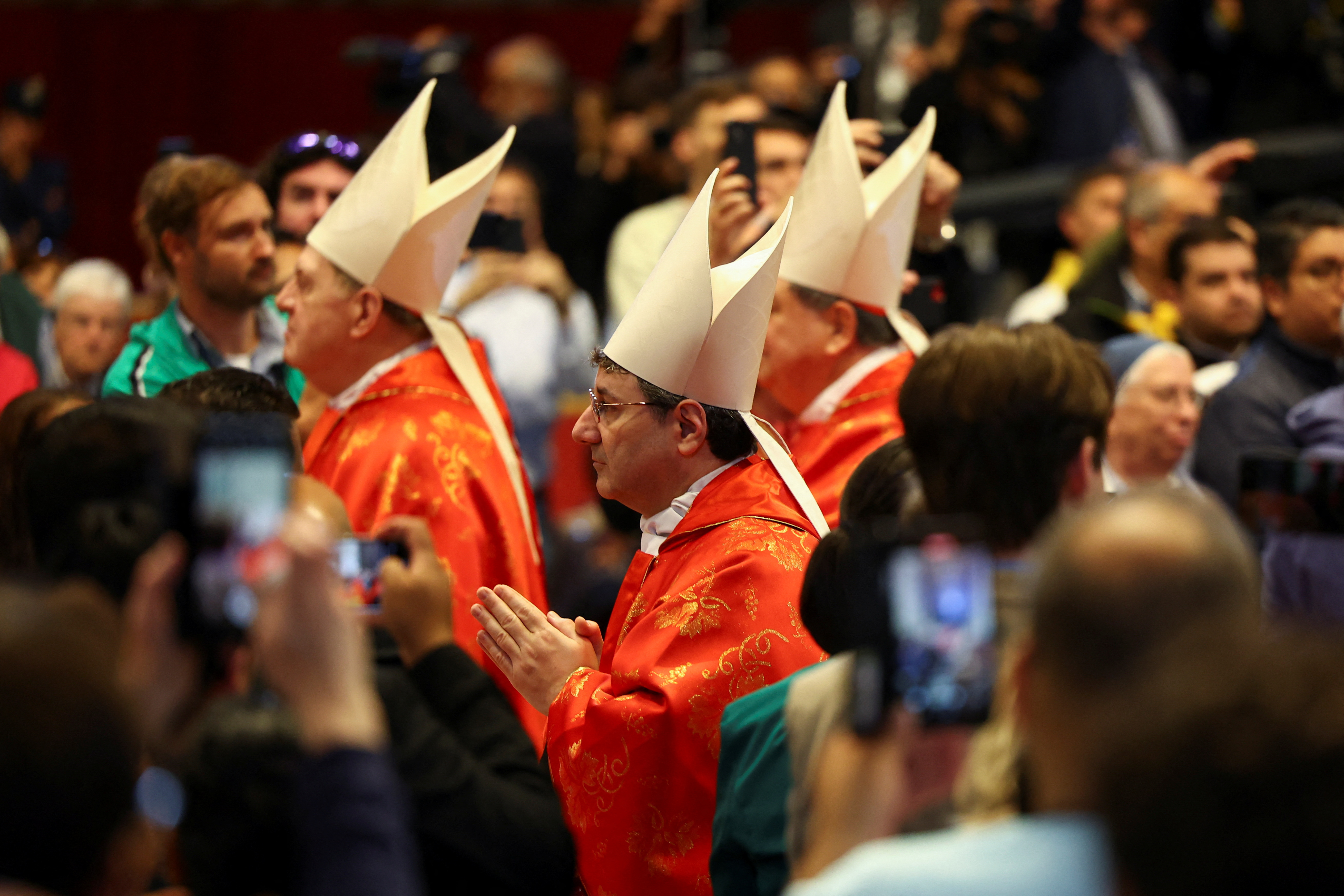 Members of the clergy walk during a mass.