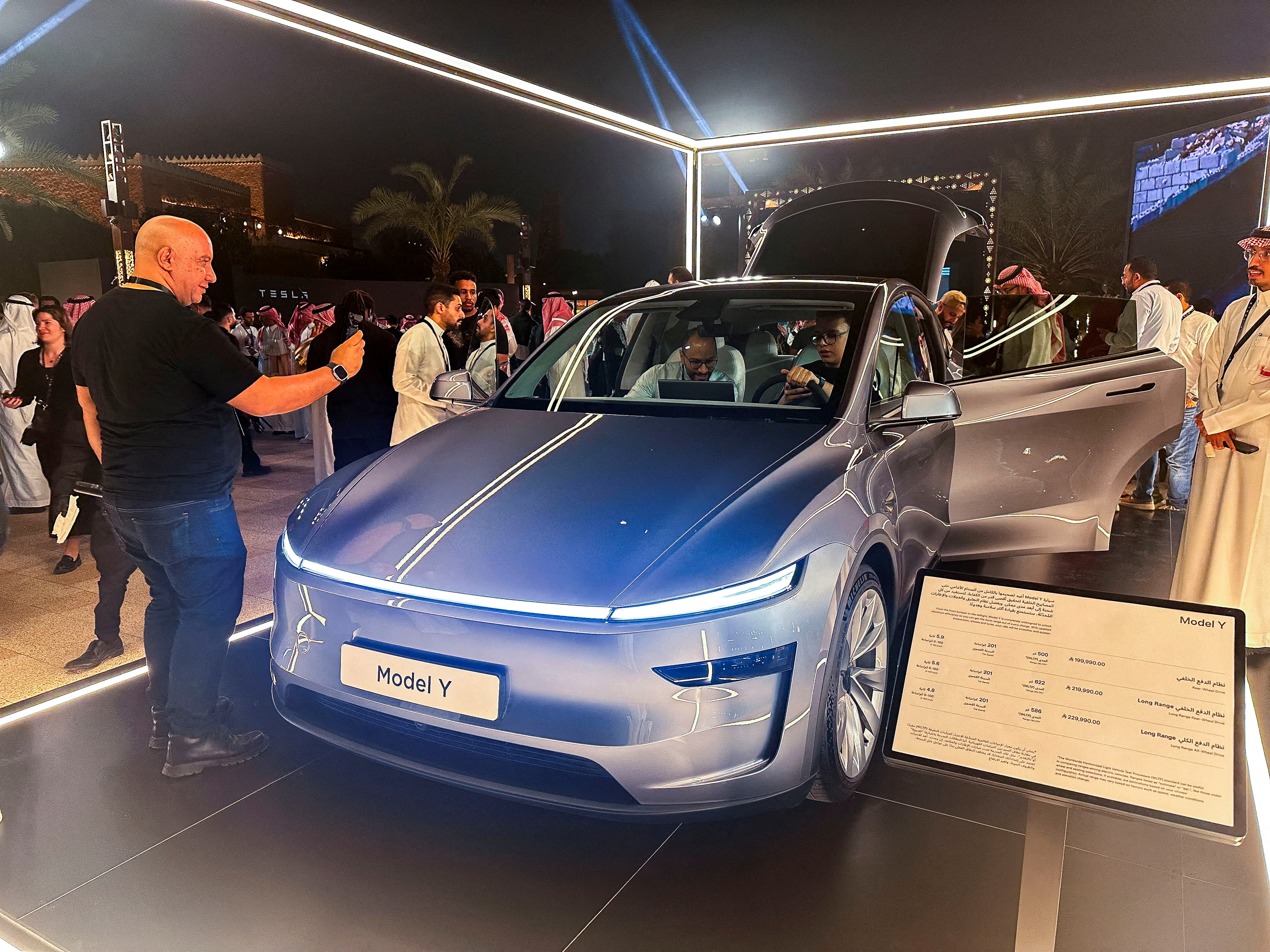 FILE PHOTO: A guest takes photos of Tesla Model Y, displayed during the inauguration ceremony of the first Tesla showroom in Riyadh, Saudi Arabia. April 10, 2025. REUTERS/Mohammed Benmansour/File Photo