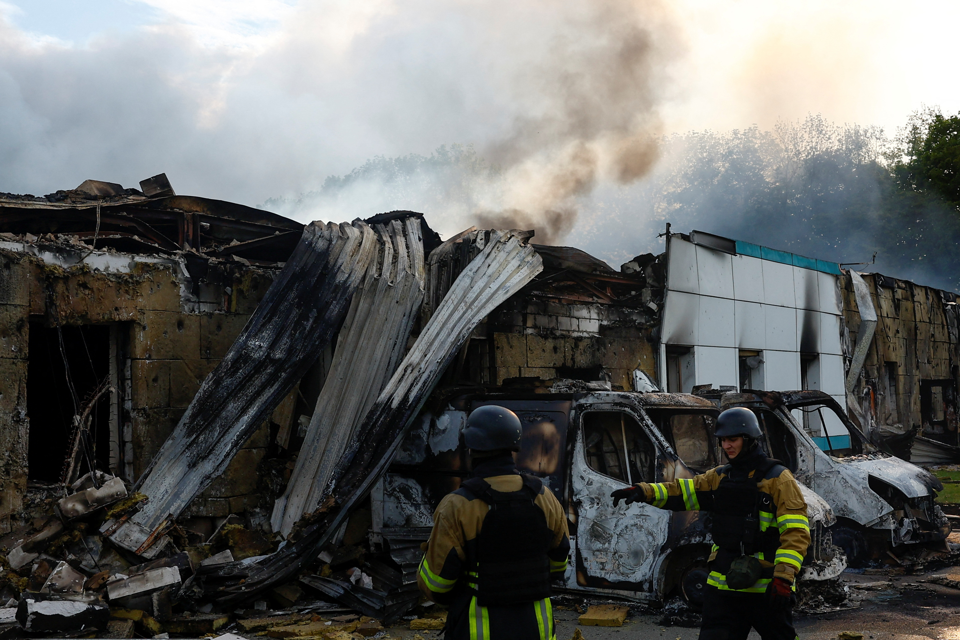 Firefighters work at the site of a private enterprise hit by a Russian drone strike, amid Russia's attack on Ukraine, outside of Kyiv, Ukraine May 18, 2025. REUTERS/Valentyn Ogirenko