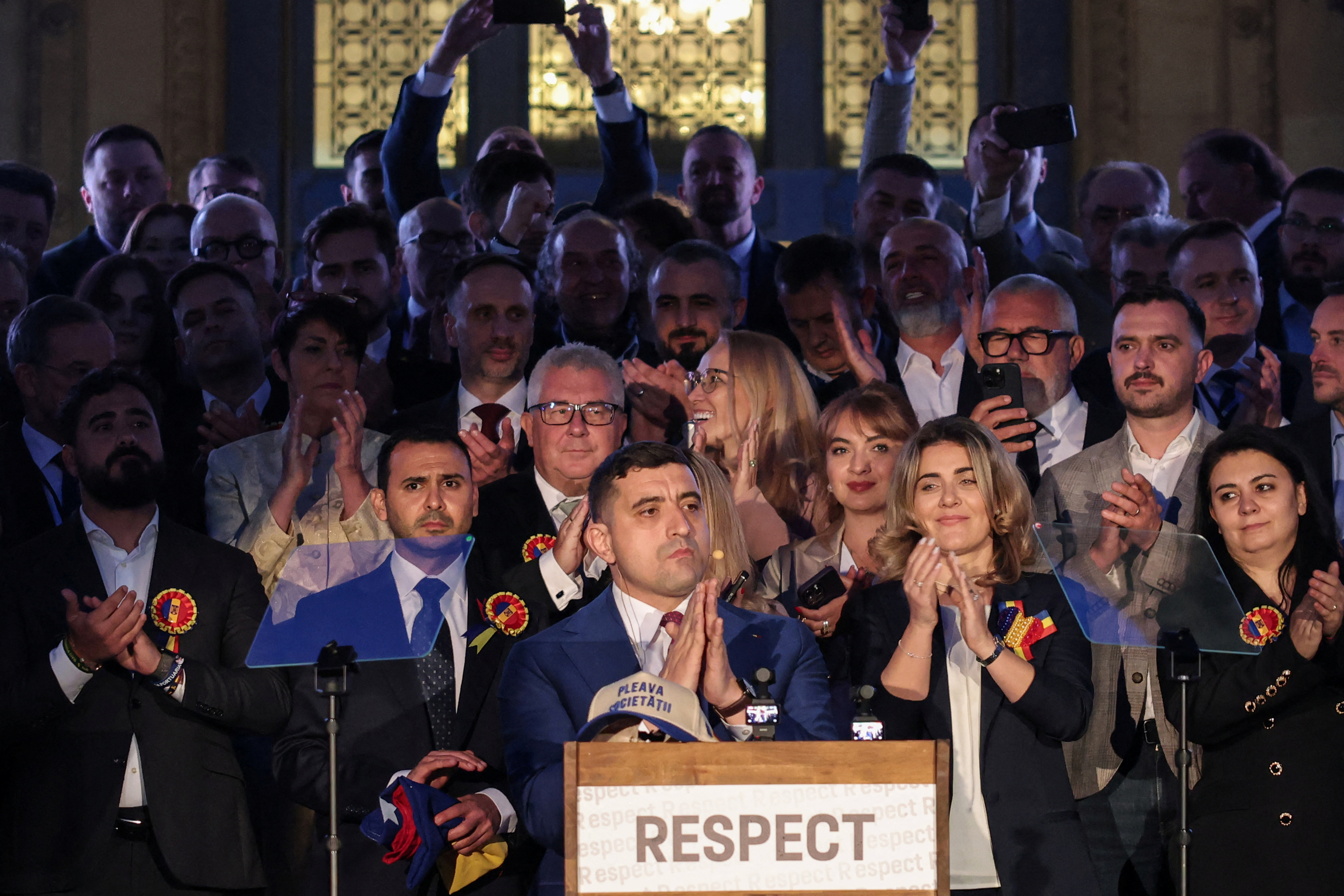 Presidential candidate George Simion reacts to exit polls of Romania's second round of the presidential election, in front of the parliament in Bucharest, Romania, May 18, 2025. REUTERS/Louisa Gouliamaki