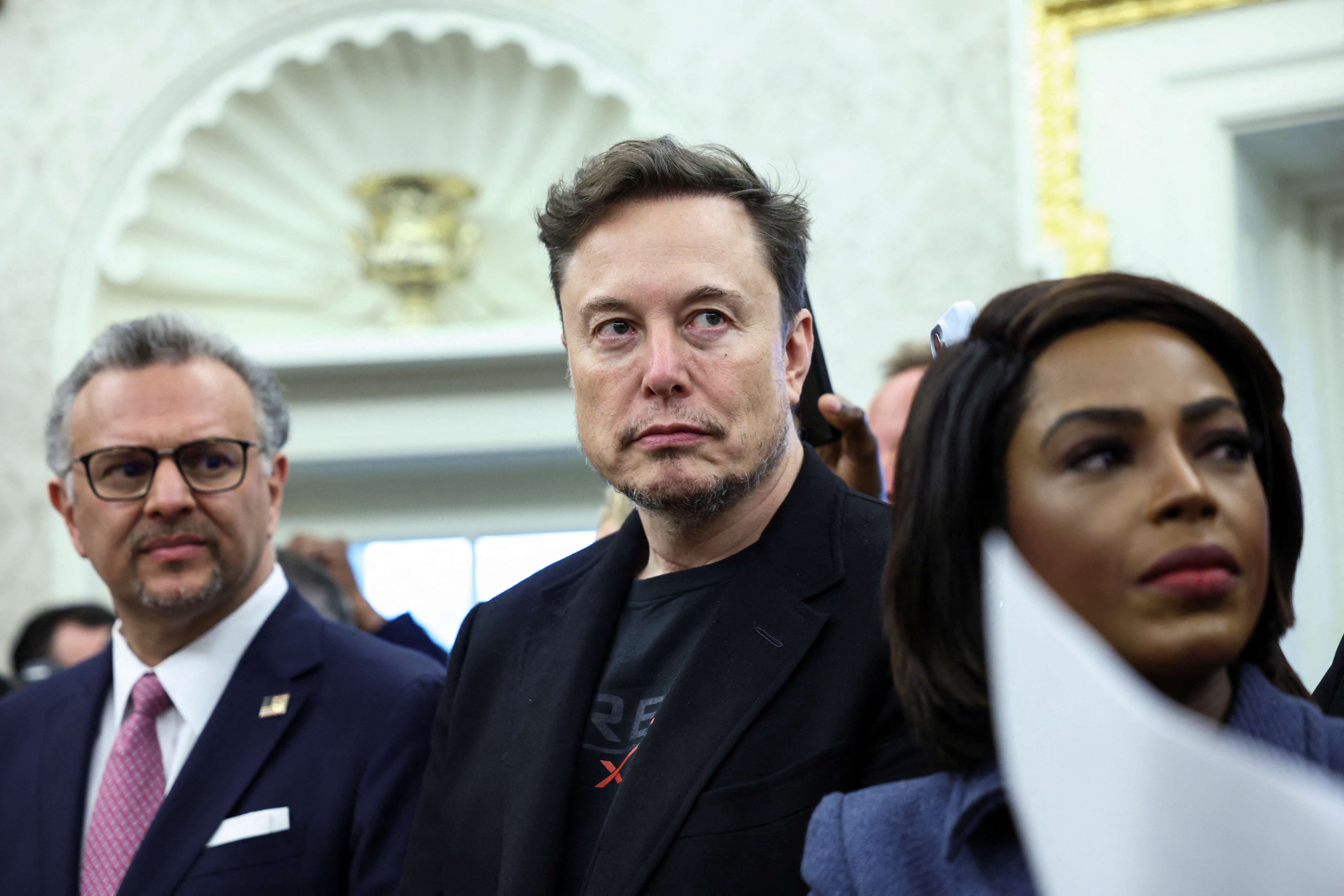 Elon Musk looks on as U.S. President Donald Trump meets South African President Cyril Ramaphosa in the Oval Office of the White House in Washington, D.C., U.S., May 21, 2025. REUTERS/Kevin Lamarque