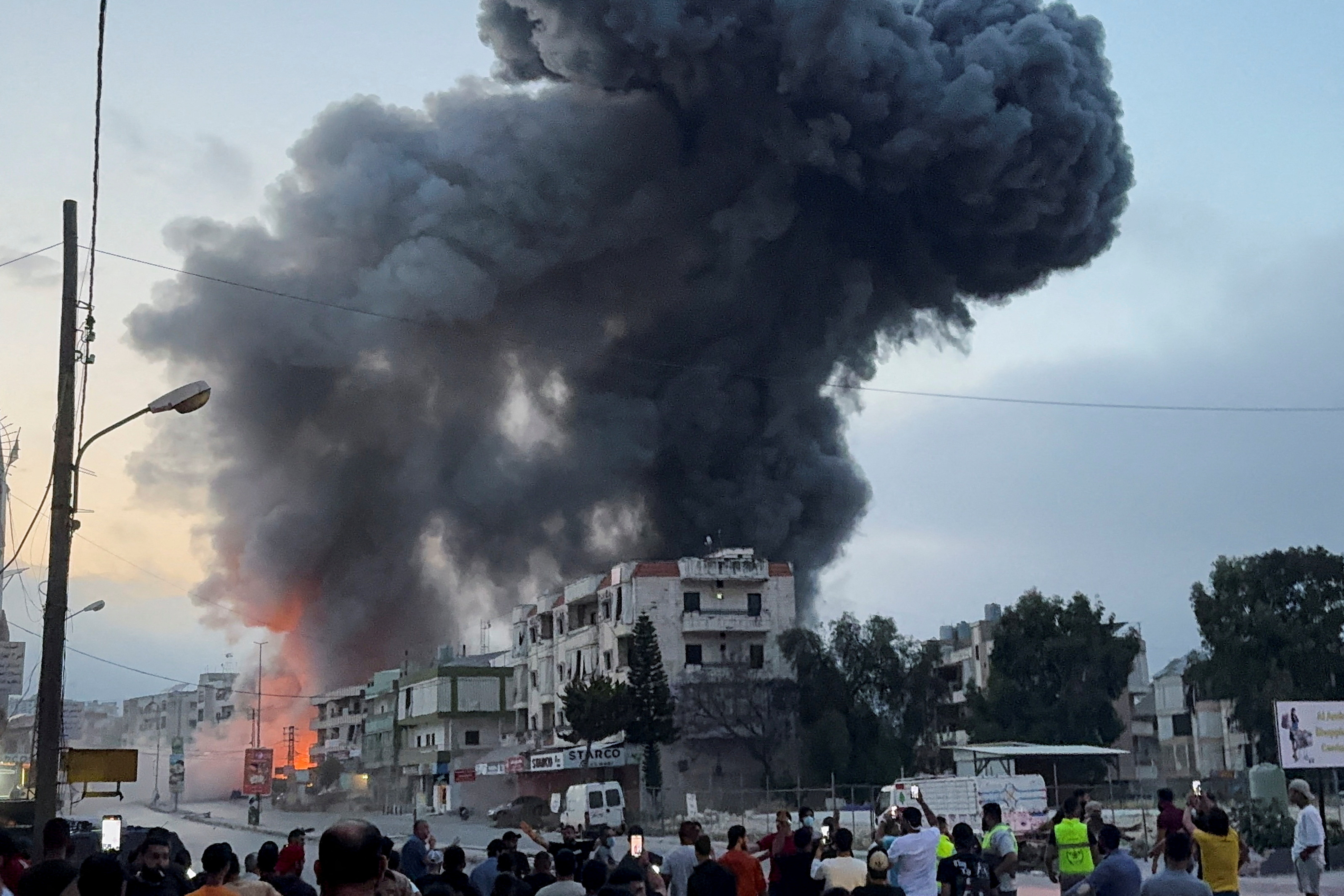 Smoke billows near buildings in the Lebanese town of Toul