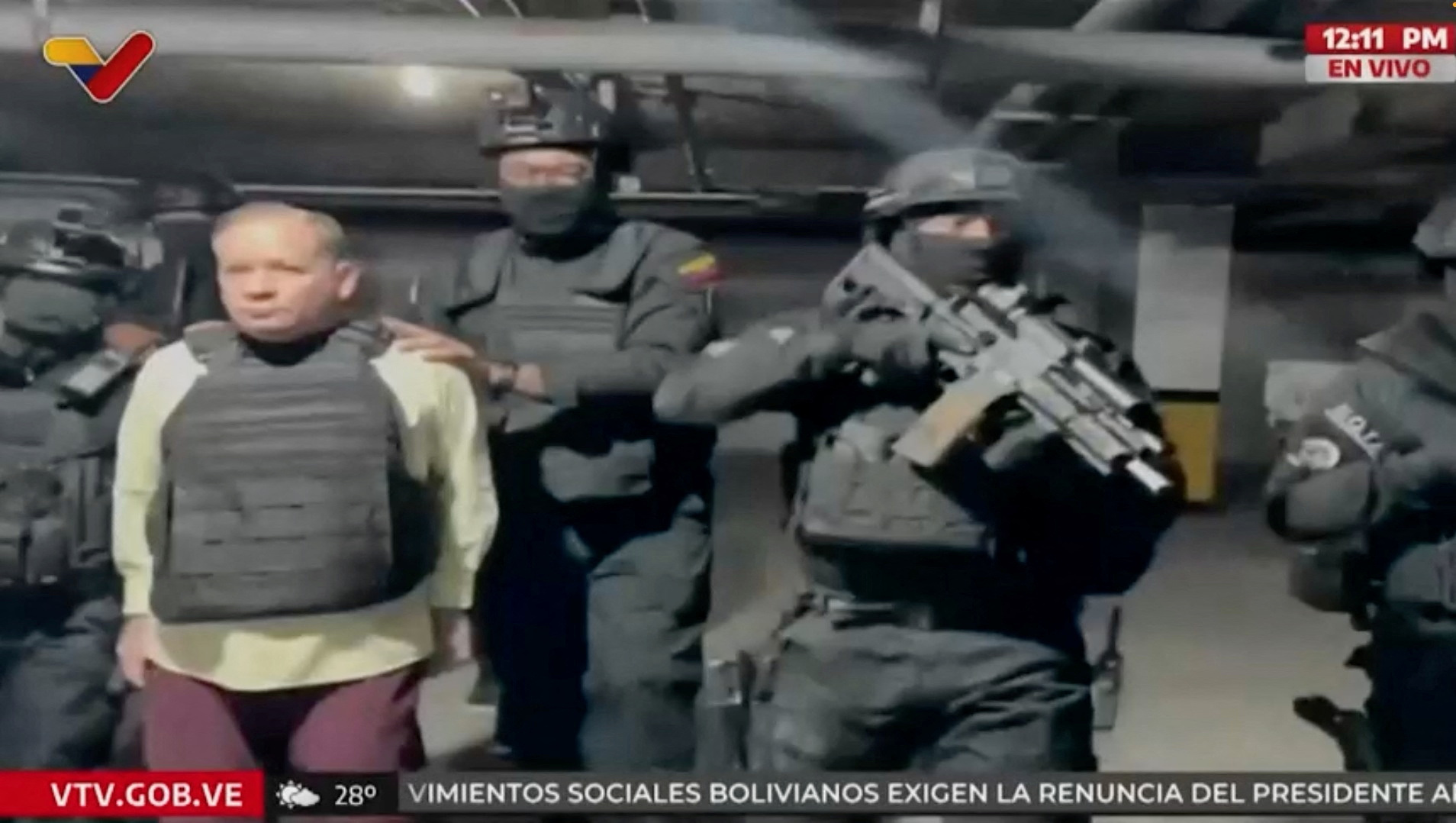 A video still shows Juan Pablo Guanipa being escorted by armed men.