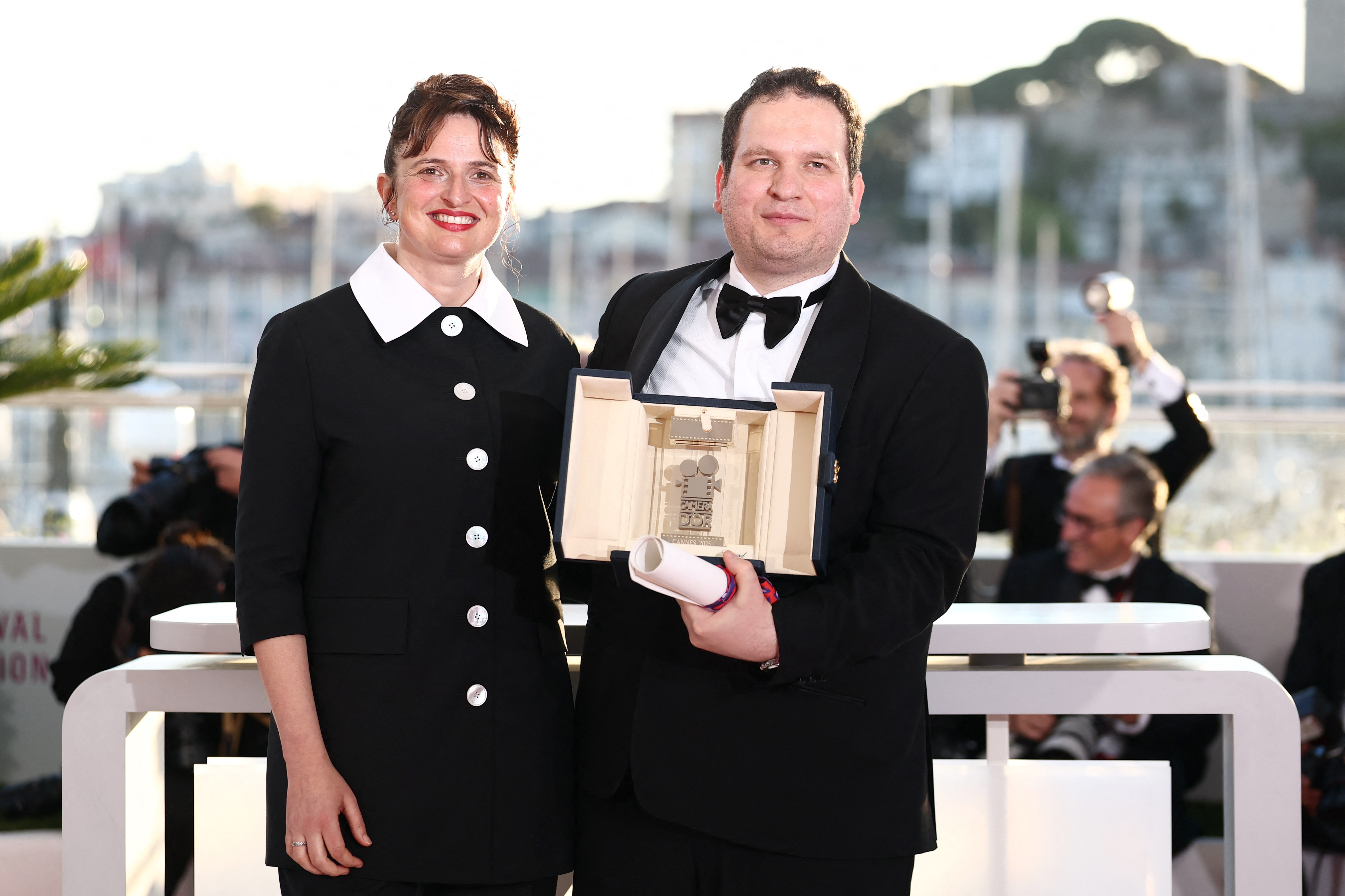 Director Hasan Hadi, Camera d'Or award winner for the film "The President's Cake" (Mamlaket al-Qasab) and Alice Rohrwacher, President of the Camera d'Or Jury, pose during a photocall after the closing ceremony of the 78th Cannes Film Festival in Cannes, France, May 24, 2025. REUTERS/Sarah Meyssonnier