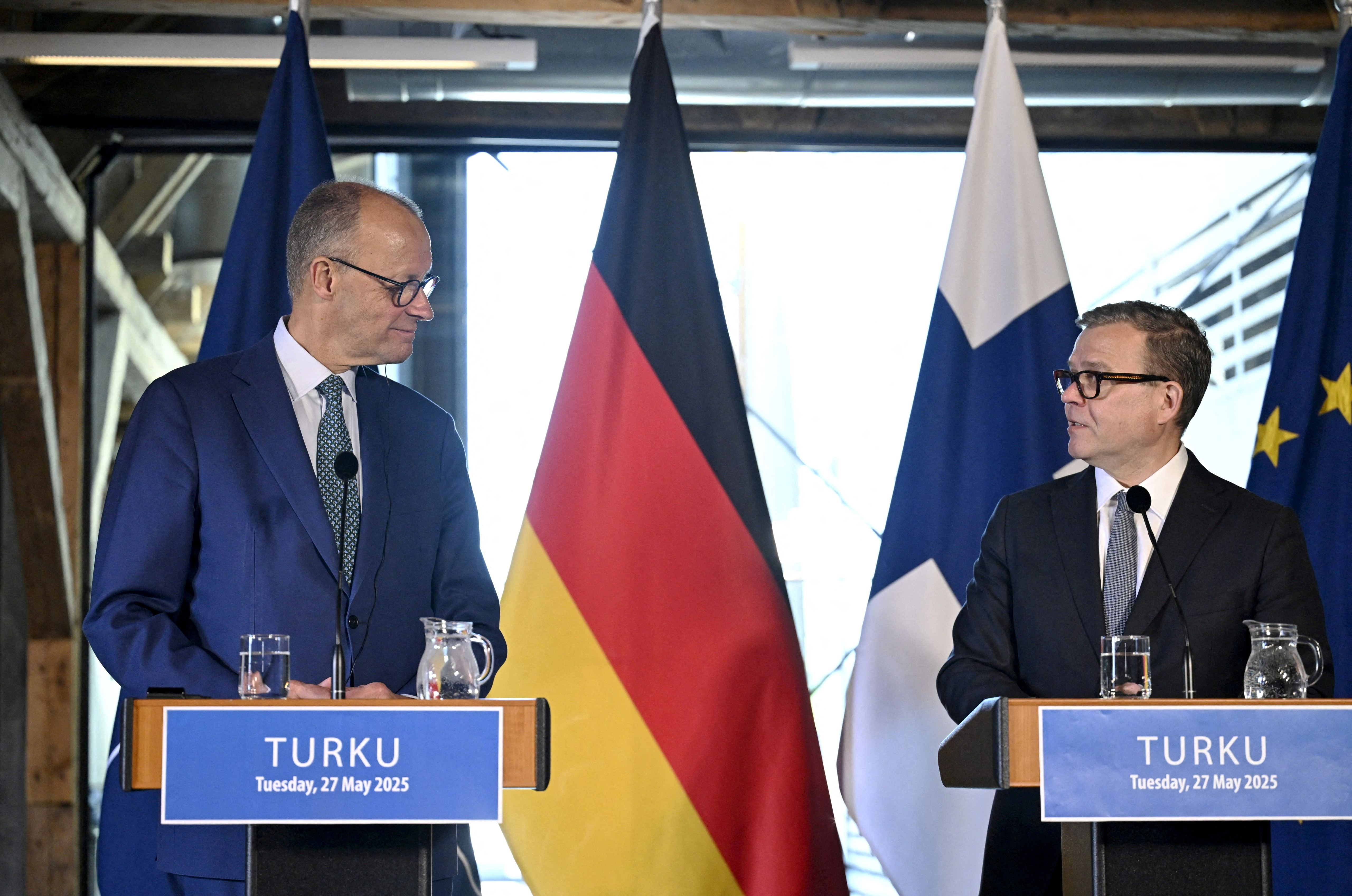 Finnish Prime Minister Petteri Orpo welcomes German Chancellor Friedrich Merz as they meet in Turku