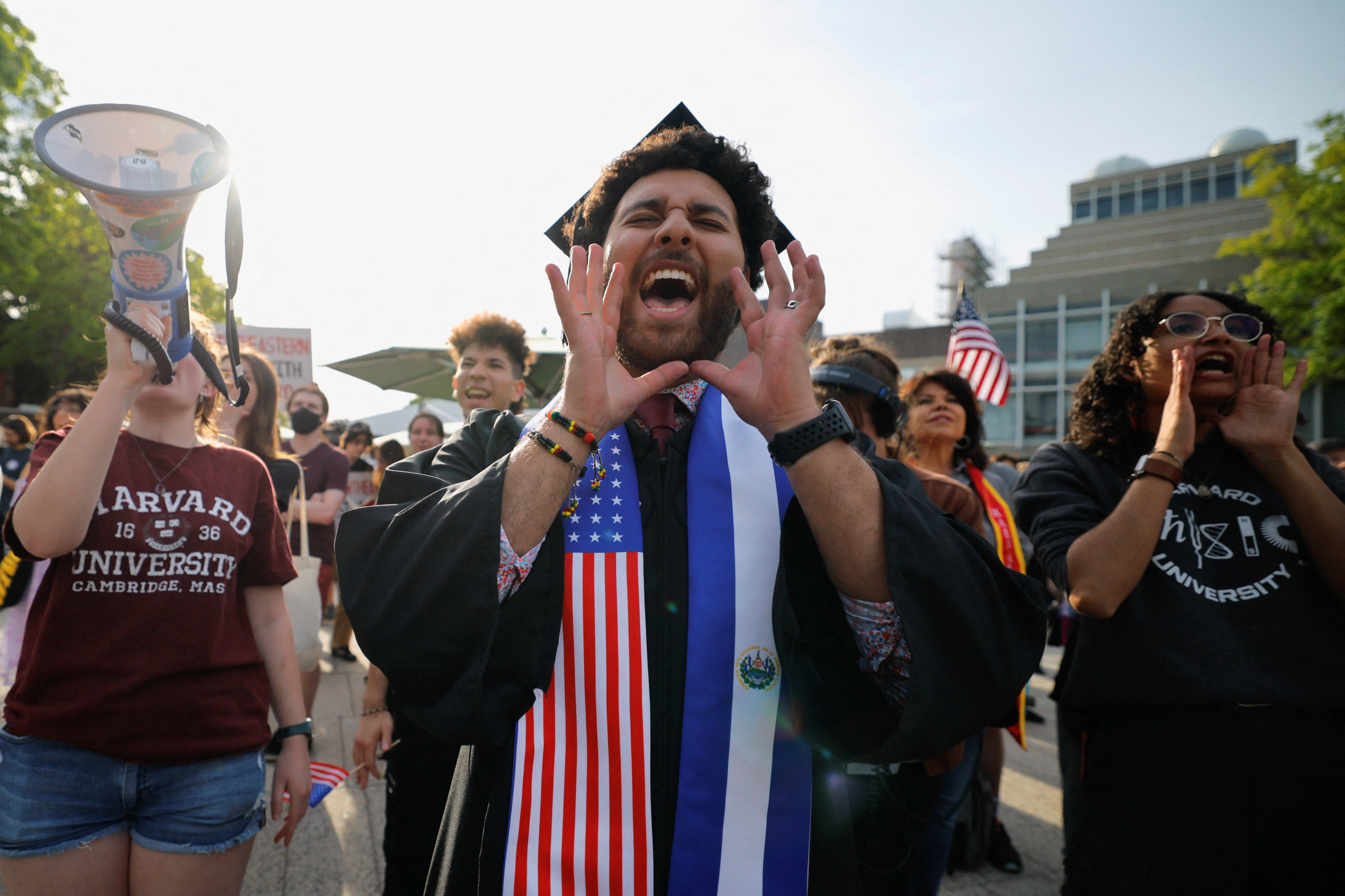A graduating student wears a stole with the flags of US and El Salvador.