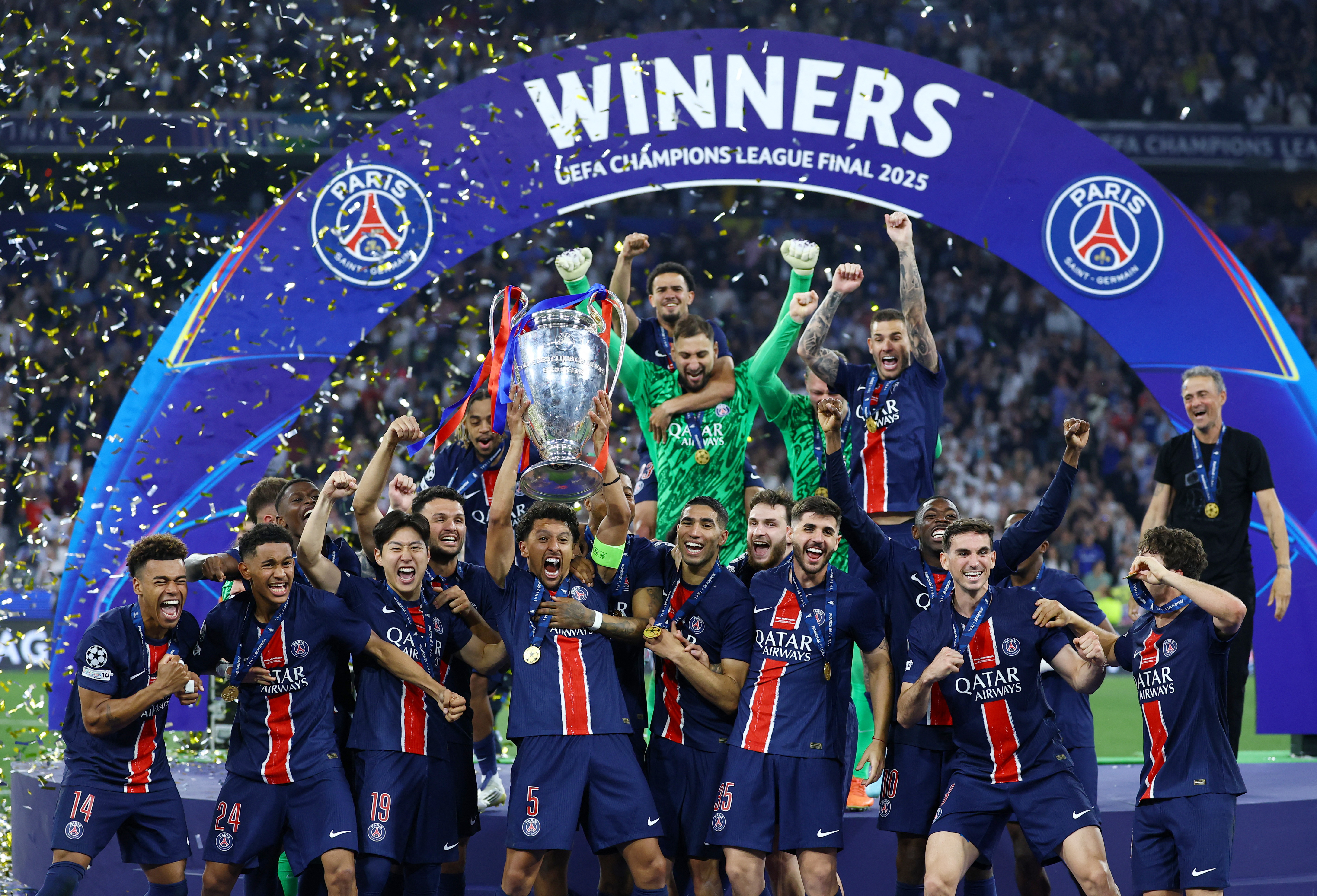 Champions League - Final - Paris St Germain v Inter Milan - Allianz Arena, Munich, Germany - May 31, 2025 Paris St Germain's Marquinhos lifts the trophy as he celebrates with teammates after winning the Champions League