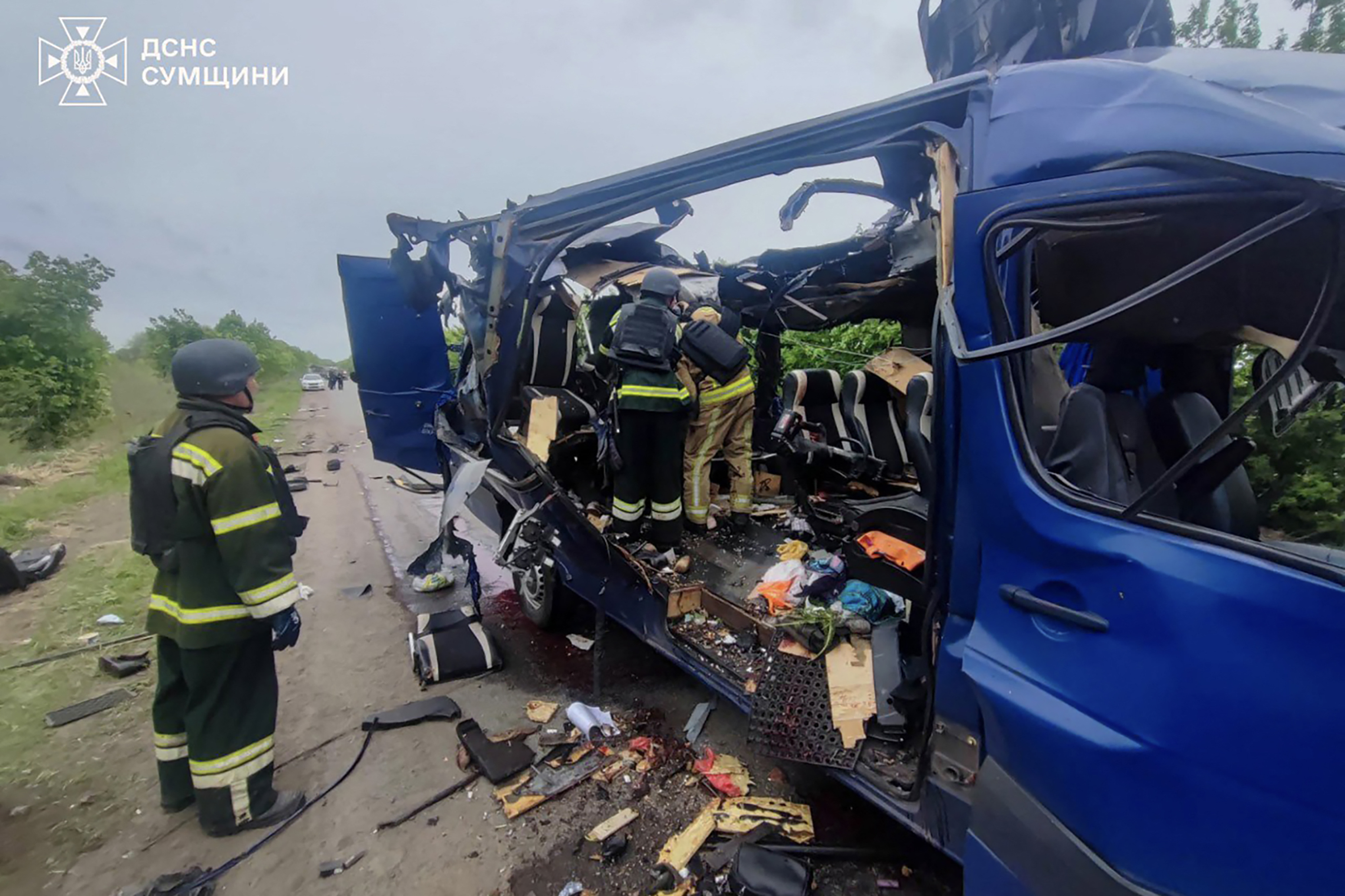 Ukrainian rescuers remove the bodies of killed passengers from a destroyed bus in Sumy