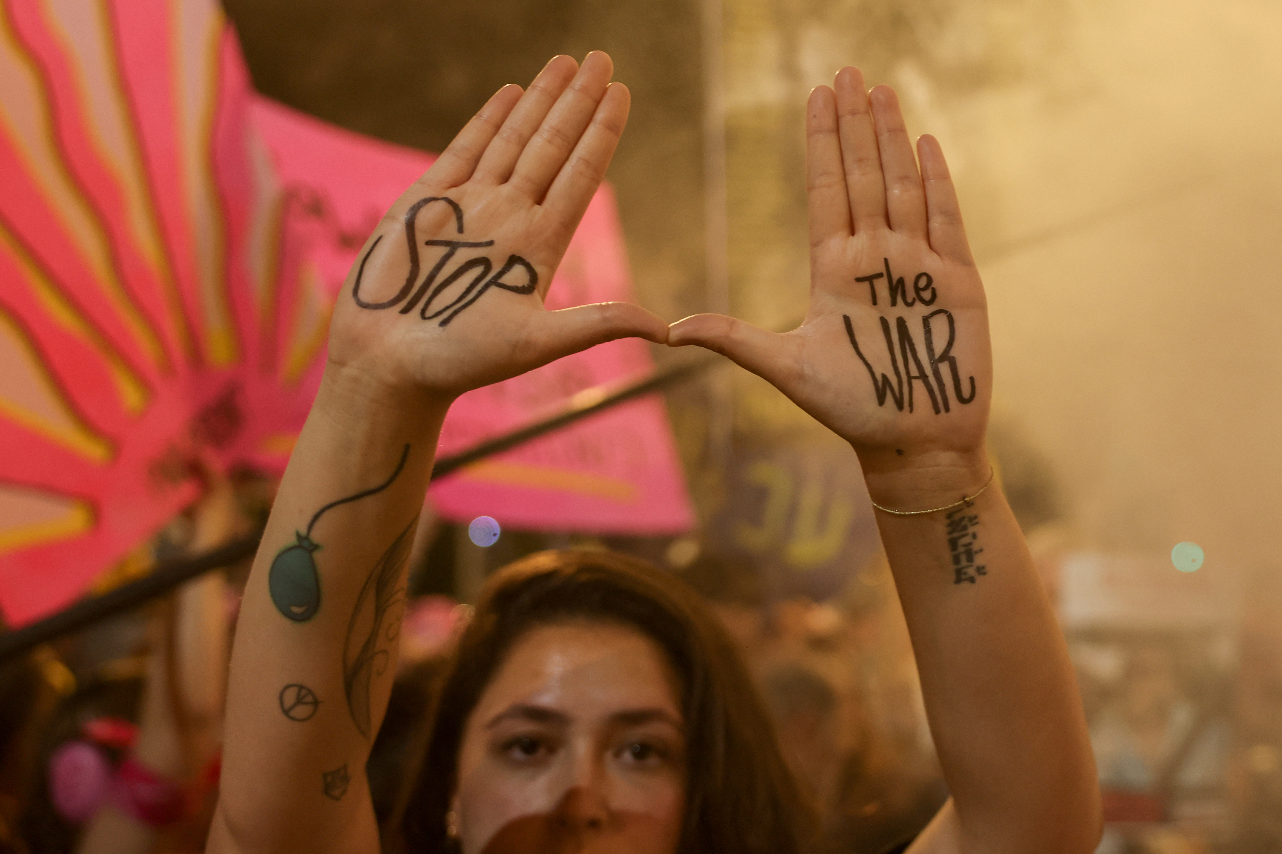 A demonstrator flashes a sign during an anti-government protest calling for the end of the war and for action to secure the release of hostages held in the Gaza Strip since the October 7, 2023 attacks.